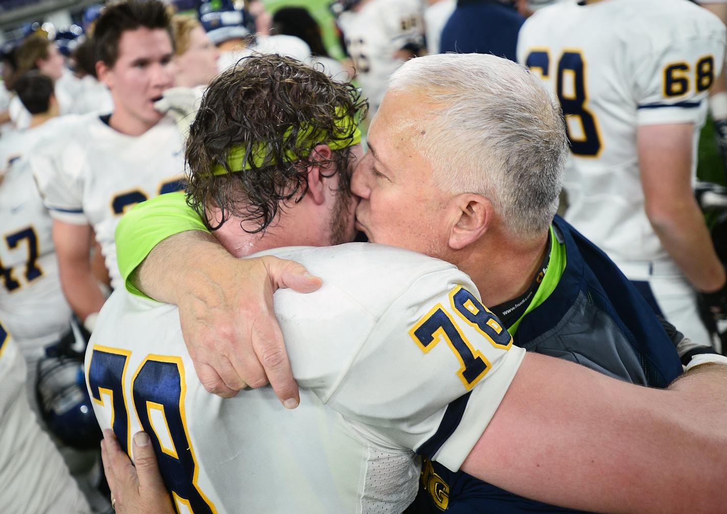 Totino Grace head coach Jeff Ferguson kissed defensive tackle Hunter Christenson (78) on the cheek after their team's 6A championship victory over Eden Prairie Friday night.