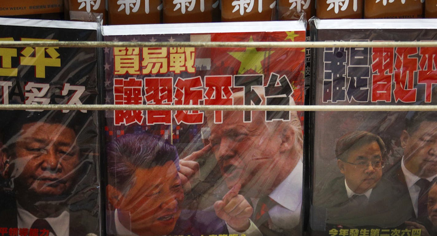 In this Thursday, July 4, 2019, photo, magazines with a front cover featuring Chinese President Xi Jinping and U.S. President Donald Trump on trade war is placed on sale at a roadside bookstand in Hong Kong. The top U.S. and Chinese trade envoys have talked by phone in their first contact since Presidents Donald Trump and Xi Jinping agreed to resume stalled talks on ending a tariff war. (AP Photo/Andy Wong)