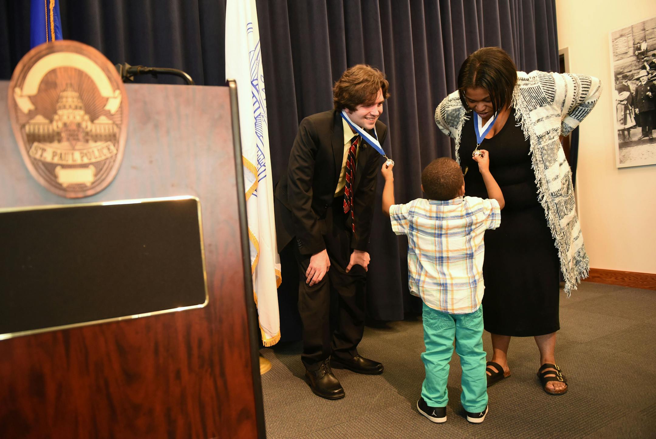 Ray Widstrand receives the chief's award for valor at the Saint Paul Police Western District building in Saint Paul on Friday, April 22, 2016.. Mr. Widstrand was nearly beaten to death in 2013 when he tried to help a woman who had fallen during a street brawl. Tanikqwa Givens, who threw herself over Ray Widstrand's body during the attack, was also honored. ] MARK KEGANS, Special to the Star-Tribune, Saint Paul, MN, April 22, 2016