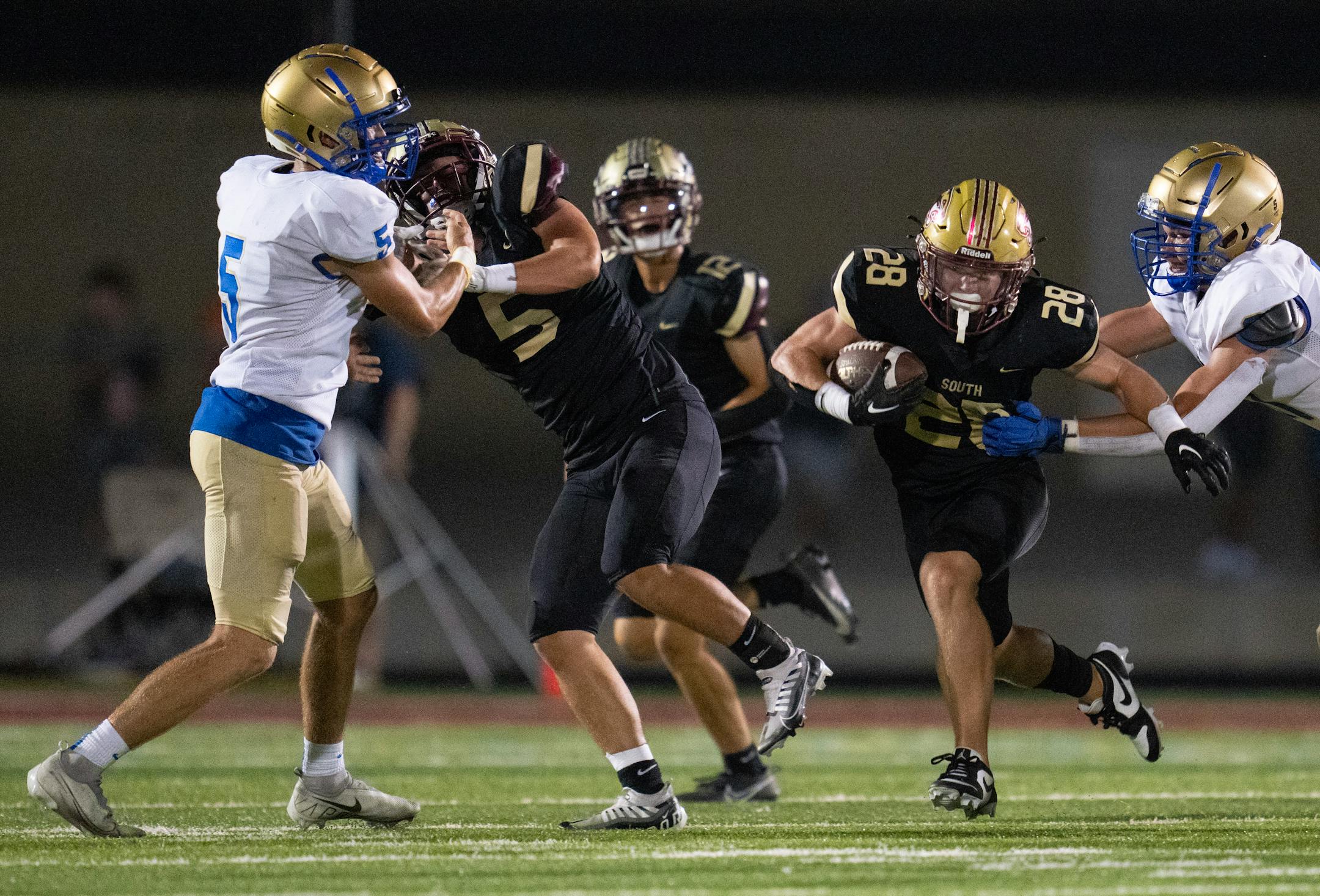 Lakeville South running back Connor Cade (28) rushes the ball against Wayzata in the third quarter Friday, Sep. 01, 2023, at Lakeville South High School in Lakeville, Minn. ]