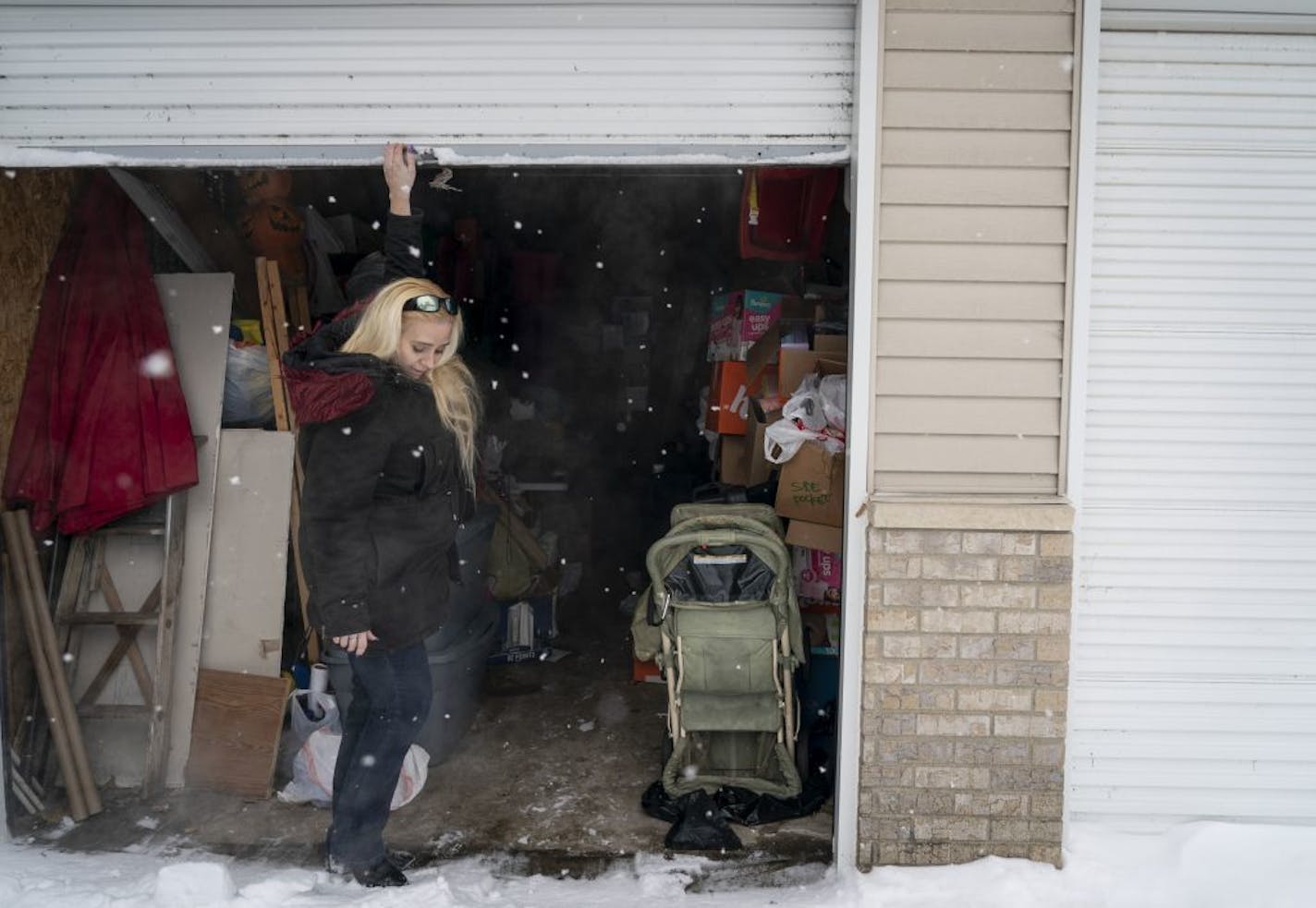 Anita Ewald closed the door after she dropped off some containers to her storage unit in Coon Rapids, Minn., on Friday, March 1, 2019. Ewald keeps her holiday decorations, presents and her six kids' school stuff and old clothes at her storage unit.