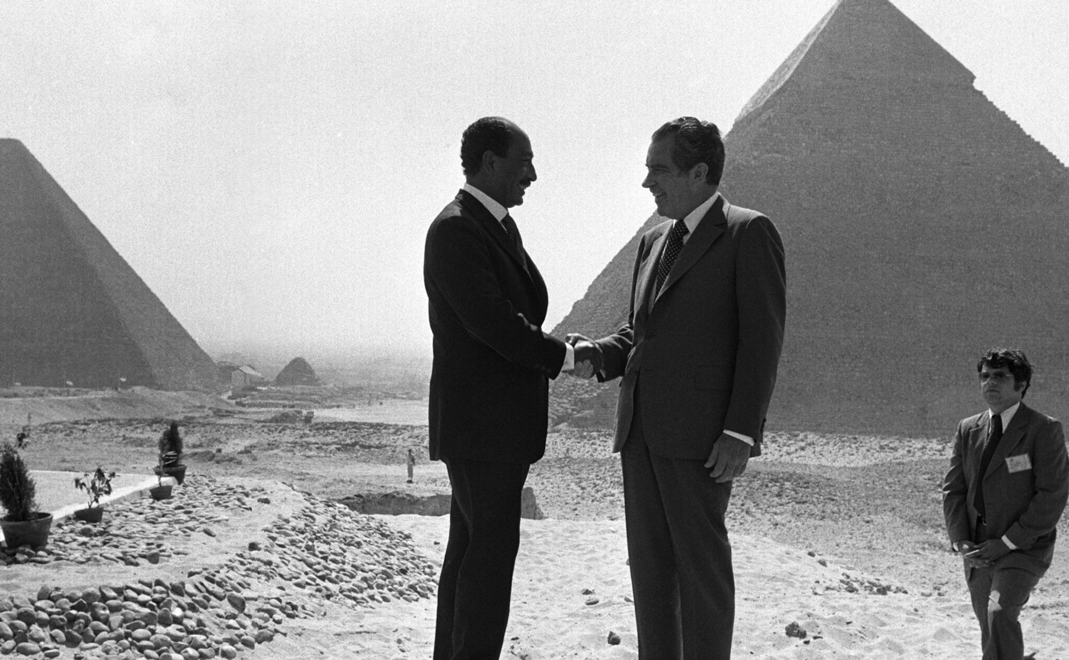 FILE - In this June 14, 1974 file photo taken by Associated Press photographer Horst Faas, Presidents Anwar Sadat and Richard Nixon shake hands for photographers as they pose in front of the pyramids at Giza, near Cairo. Faas, a prize-winning combat photographer who carved out new standards for covering war with a camera and became one of the world's legendary photojournalists in nearly half a century with The Associated Press, died Thursday May 10, 2012. He was 79. (AP Photo/Horst Faas, File) O