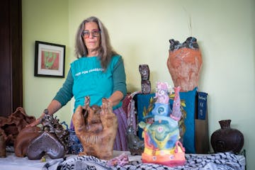 Artist Sharon Jaffe with a collection of her ceramic golems at her Minneapolis home last week. Eight Jewish artists will participate in a five-day exh