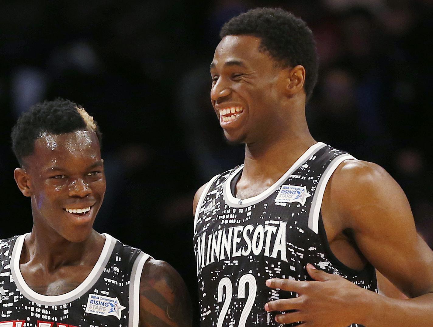 World Team's Dennis Schroder, left, of the Atlanta Hawks, and Andrew Wiggins, of the Minnesota Timberwolves, talk during the second half against the U.S. Team in NBA basketball's Rising Stars Challenge, Friday, Feb. 13, 2015, in New York. (AP Photo/Julio Cortez)