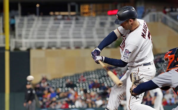 The Twins' Joe Mauer hits against the Tigers in the sixth inning Wednesday.