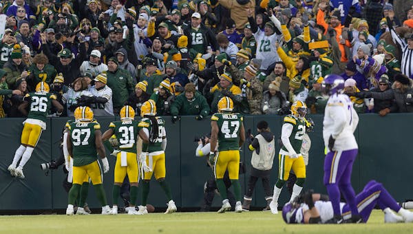 Green Bay Packers safety Darnell Savage (26) jumps into the stands for a "Lambeau Leap" after he intercepted the ball in the first quarter the Minneso