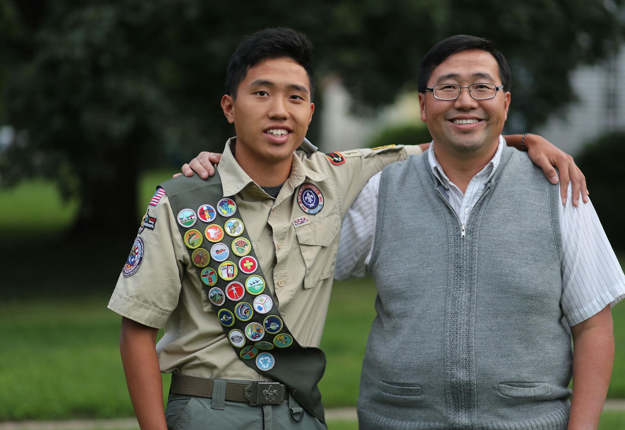 Aaron Yang, of Troop 184, will become the councilís first second generation Eagle Scout in ceremonies today at the troopís chartering organization, Christ Lutheran Church. Here, Aaron is seen with his father Xia Yang, who was the councilís first Hmong Eagle Scout in 1989, outside their home Friday, Aug. 26, 2016, in St. Paul, MN.](DAVID JOLES/STARTRIBUNE)djoles@startribune Aaron Yang, of Troop 184, will become our councilís first second generation Eagle Scout in ceremonies at