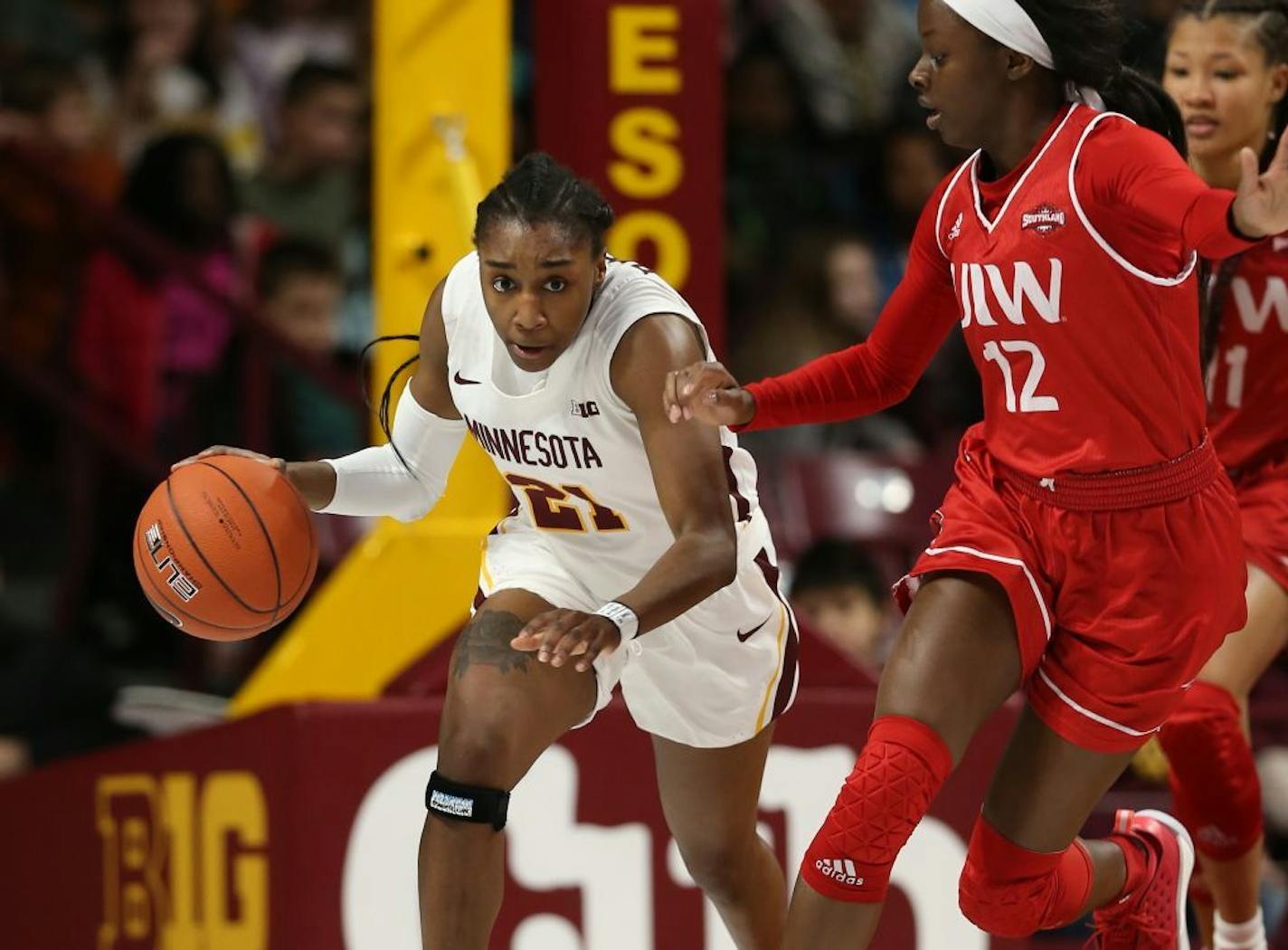 Jasmine Brunson(21) drives for the open court past Angelica Wiggins(12) of Incarnate Word.