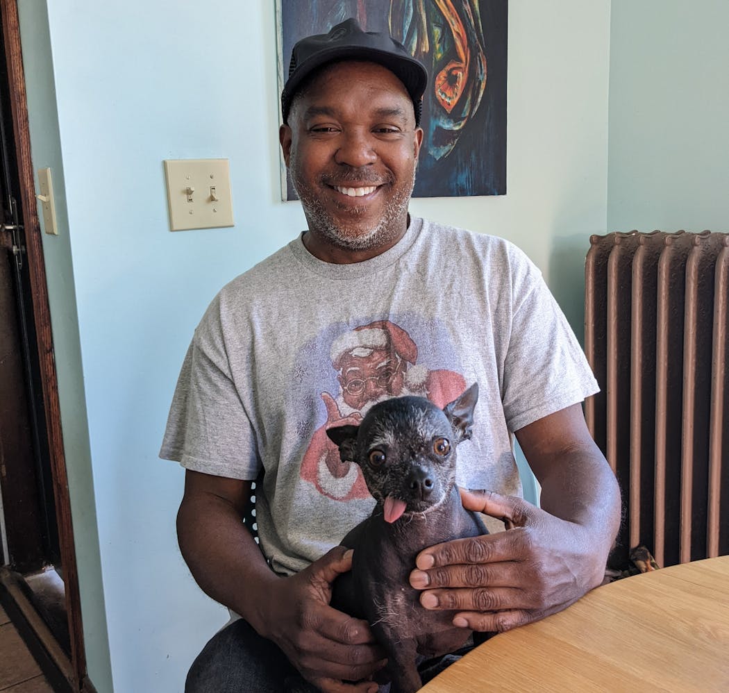 Artist Lamar Peterson, winner of a 2024 Guggenheim Fellowship, in his kitchen with his dog, Bea, (named after Bea Arthur).