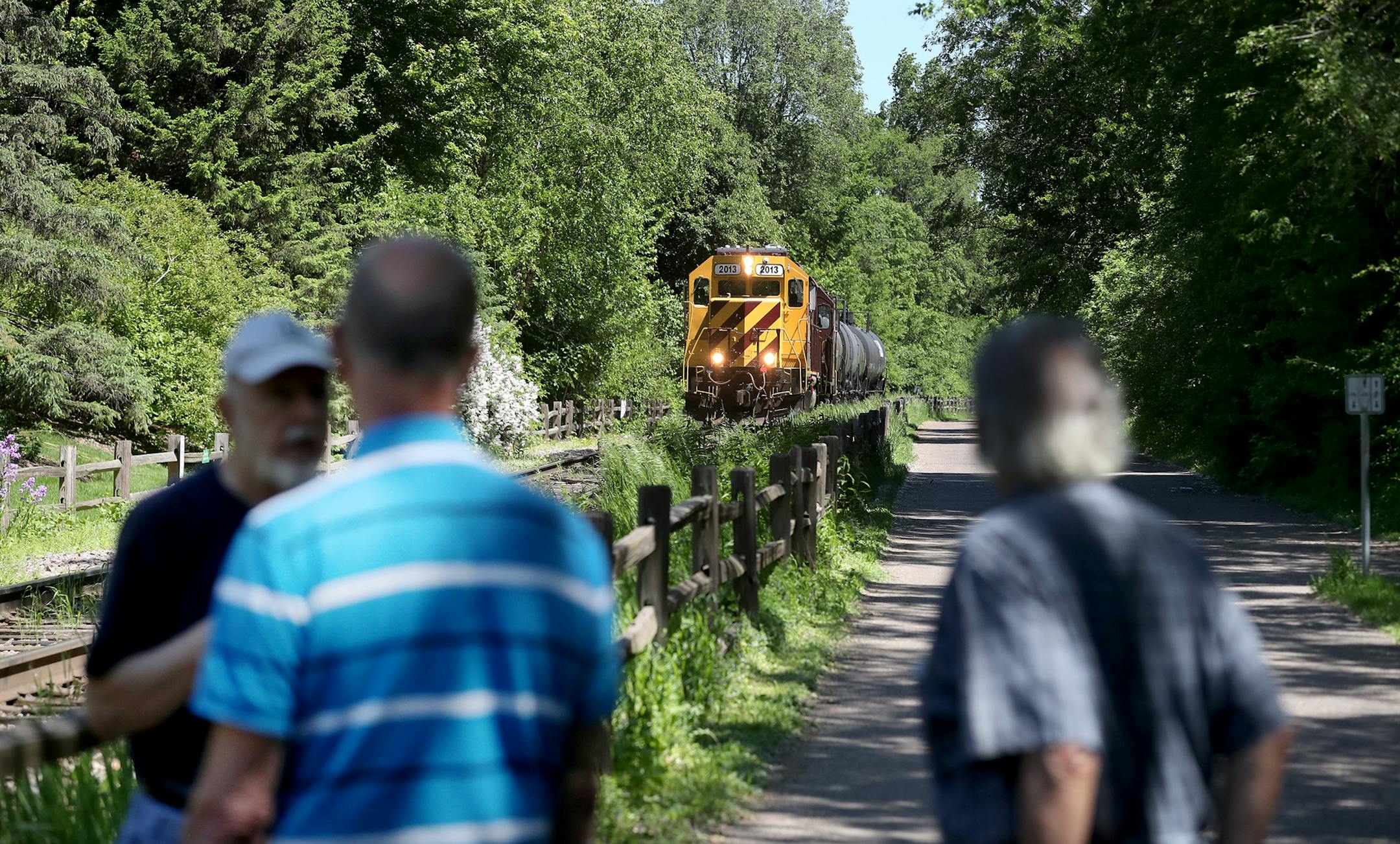 While talking about the proposed Southwest light rail, Paul Petzschke, right to left, and Nick Shuraleff, residents at the Calhoun-Isles condo complex, and neighbor Doug Peterson, encountered a train pulling seemingly empty oil tanker cars near the condo complex Wednesday, May 31, 2017, in Minneapolis, MN. &#xec;I&#xed;m just very concerned about how the vibrations are going to hit this building,&#xee; said Petzschke, a retired engineer, referring to the nearby condo right rise and the proposed