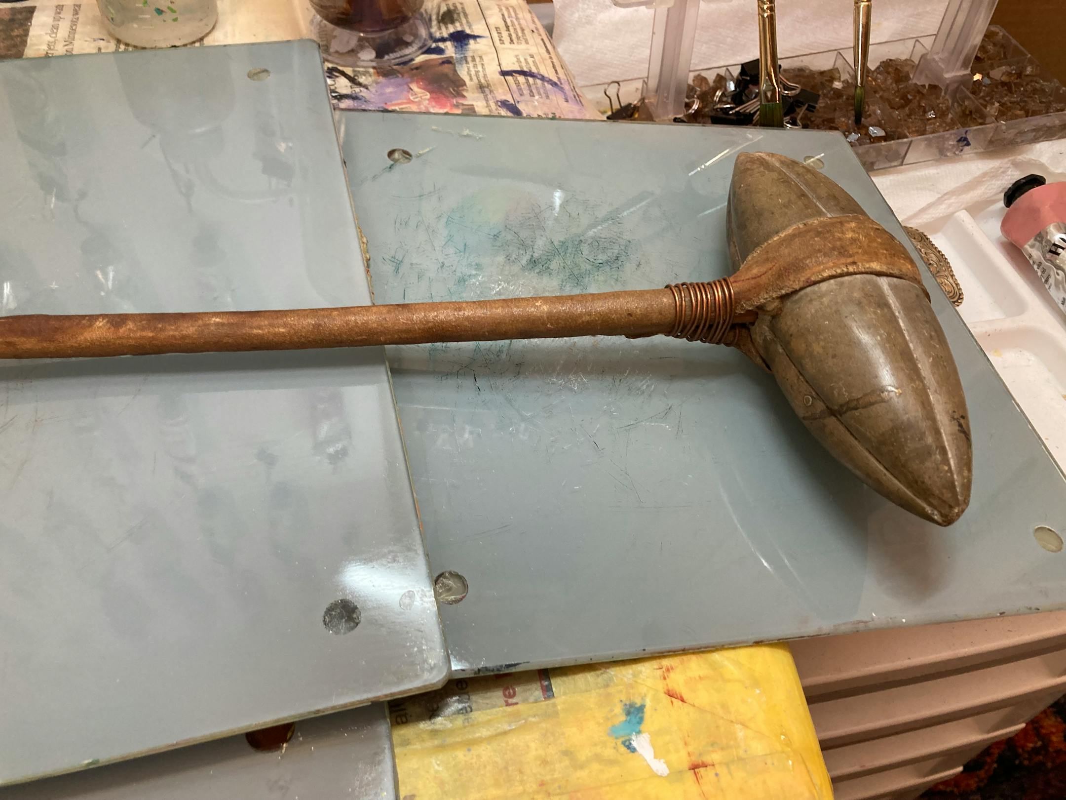 A stone club sits on a table