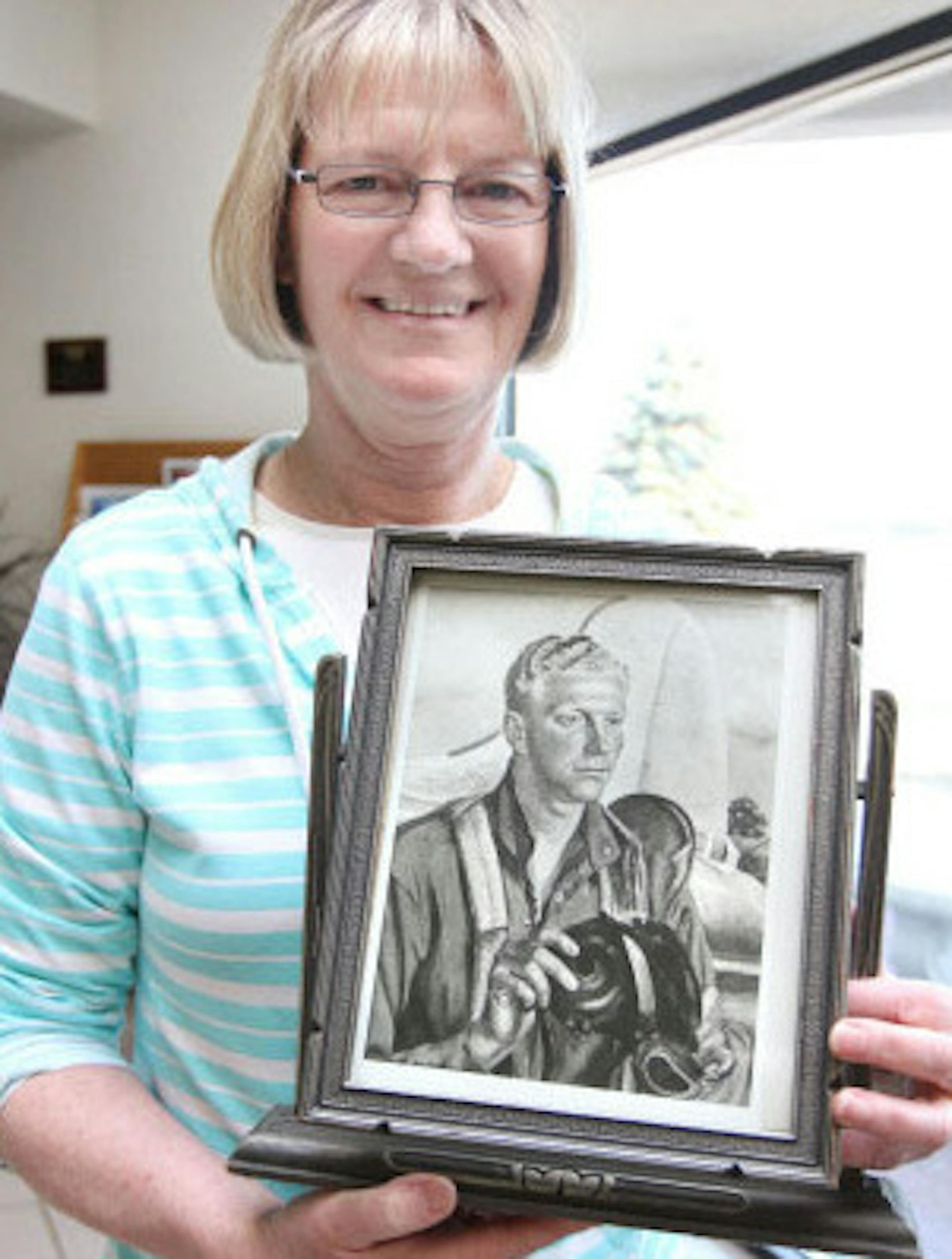 Caralee Bjerkness, Roy Schellin's daughter, held a copy of a painting of the late World War II veteran from Brainerd, Minn. The original hangs at the Pentagon. The family recently found out about its whereabouts and plans to see the portrait this summer.