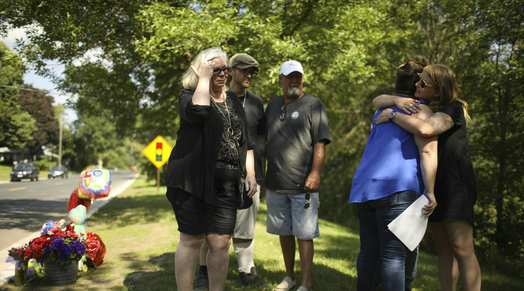 Kourtney Nordrum, holding papers in her hand, was hugged after reading a statement from her family about her brother, Johnathan O'Shaughnessy, near a memorial to him on E. 64th St. in Richfield. ] JEFF WHEELER &#xef; jeff.wheeler@startribune.com The sister of the man killed in a drive-by shooting in Richfield read a statement from her family to the news media at the spot on E. 64th St. where Johnathan O'Shaughnessy was gunned down. O'Shaughnessy's sister, Kourtney Nordrum, spoke to reporters Wed
