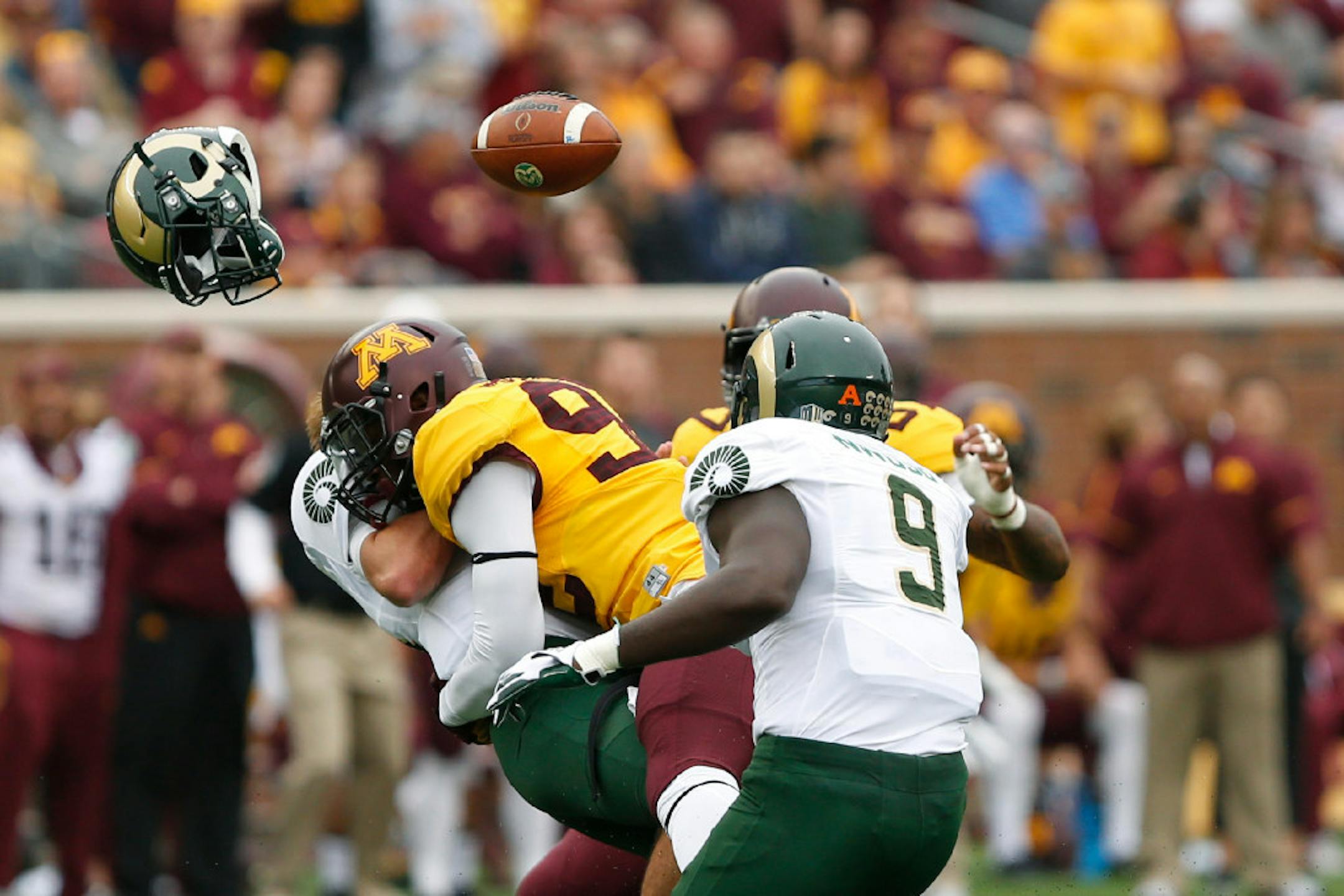 Colorado State quarterback Collin Hill loses his helmet and football after being tackled by Minnesota defensive lineman Tai'yon Devers during an NCAA college football game Saturday, Sept. 24, 2016, in Minneapolis.