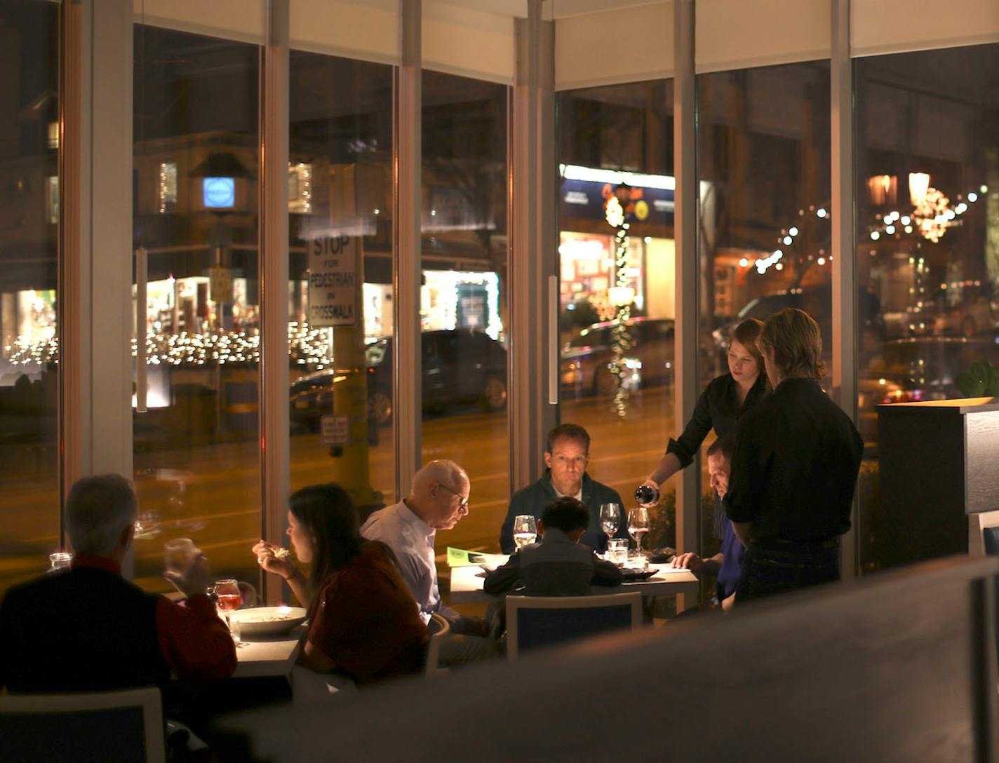 Two tables at the front of Upton 43 have a view of the comings and goings in downtown Linden Hills.