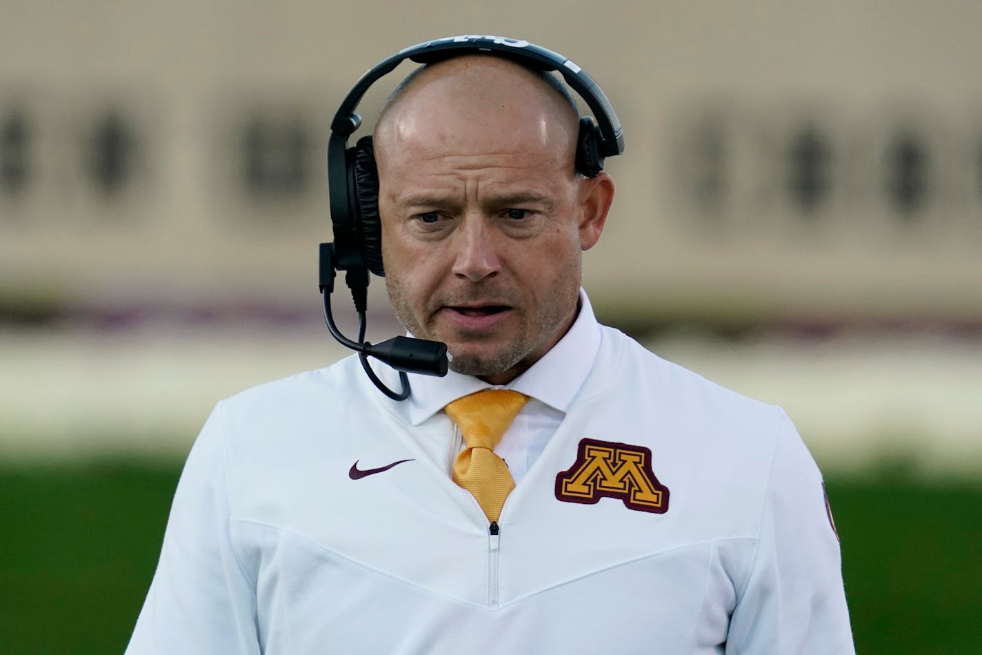 Minnesota head coach P.J. Fleck talks on the radio during the second half of an NCAA college football game against Northwestern in Evanston, Ill., Saturday, Oct. 30, 2021. (AP Photo/Nam Y. Huh)