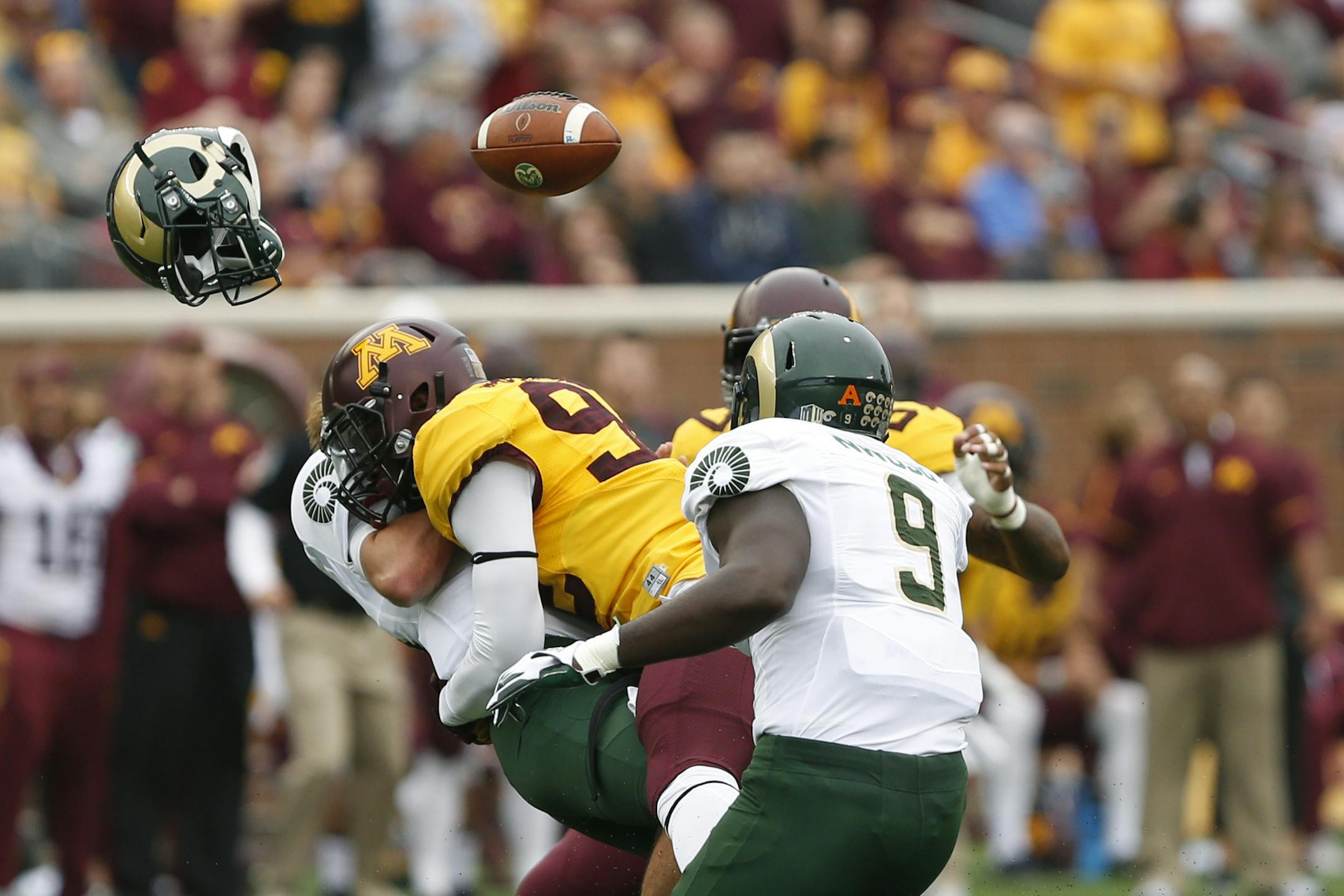 Colorado State quarterback Collin Hill loses his helmet and football after being tackled by Minnesota defensive lineman Tai'yon Devers during an NCAA college football game Saturday, Sept. 24, 2016, in Minneapolis. (AP Photo/Stacy Bengs)