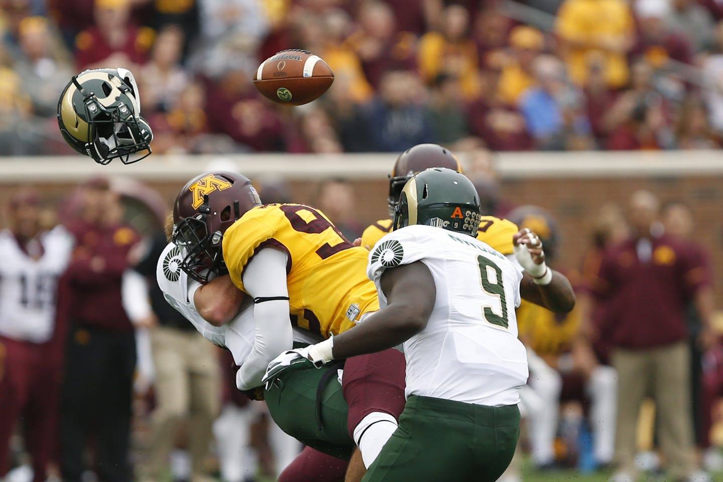 Colorado State quarterback Collin Hill loses his helmet and football after being tackled by Minnesota defensive lineman Tai'yon Devers during an NCAA college football game Saturday, Sept. 24, 2016, in Minneapolis. (AP Photo/Stacy Bengs)