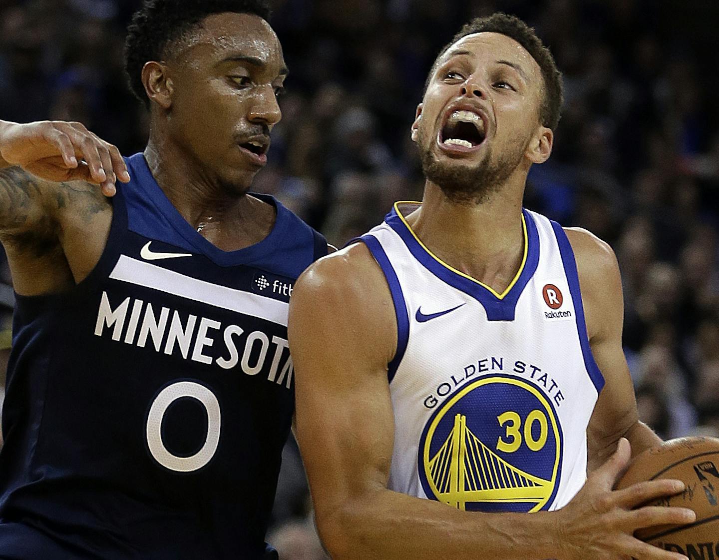 Golden State Warriors' Stephen Curry, right, drives the ball against Minnesota Timberwolves' Jeff Teague during the second half of an NBA basketball game Wednesday, Nov. 8, 2017, in Oakland, Calif. (AP Photo/Ben Margot)