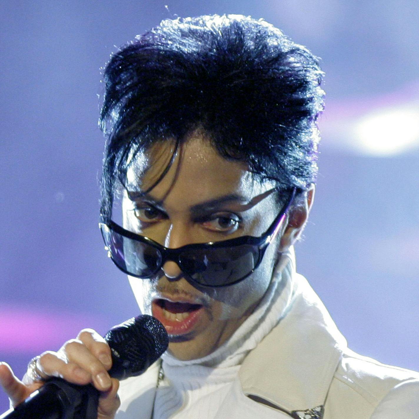 ** FILE ** Prince performs during the 2007 National Council of La Raza ALMA Awards in Pasadena, Calif. in this June 1, 2007, file photo. Prince is taking legal action to stop Web sites from using copyrighted images, a concert promotion company announced Friday, Nov. 9, 2007. Contrary to reports, the Purple One is not suing his fans or looking to inhibit free speech in any way, AEG, which promoted Prince's concert series in London, said in a statement. (AP Photo/Mark J. Terrill, file) ORG XMIT: N