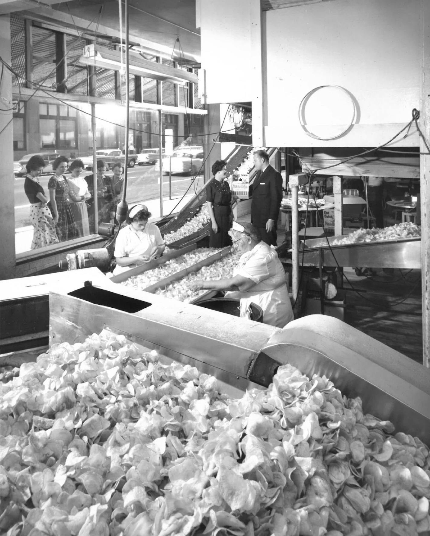 Passersby peer into the Old Dutch factory in downtown Minneapolis during the 1950s.