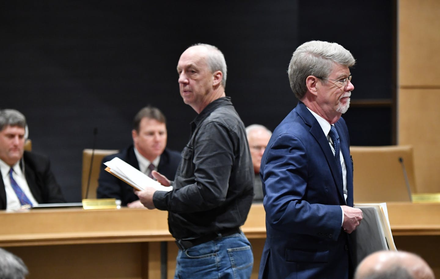 Donny Vosen, left, deputy registrar in Brainerd passed State Legislative Auditor Jim Nobles as they spoke to the committee about the problems with MNLARS.