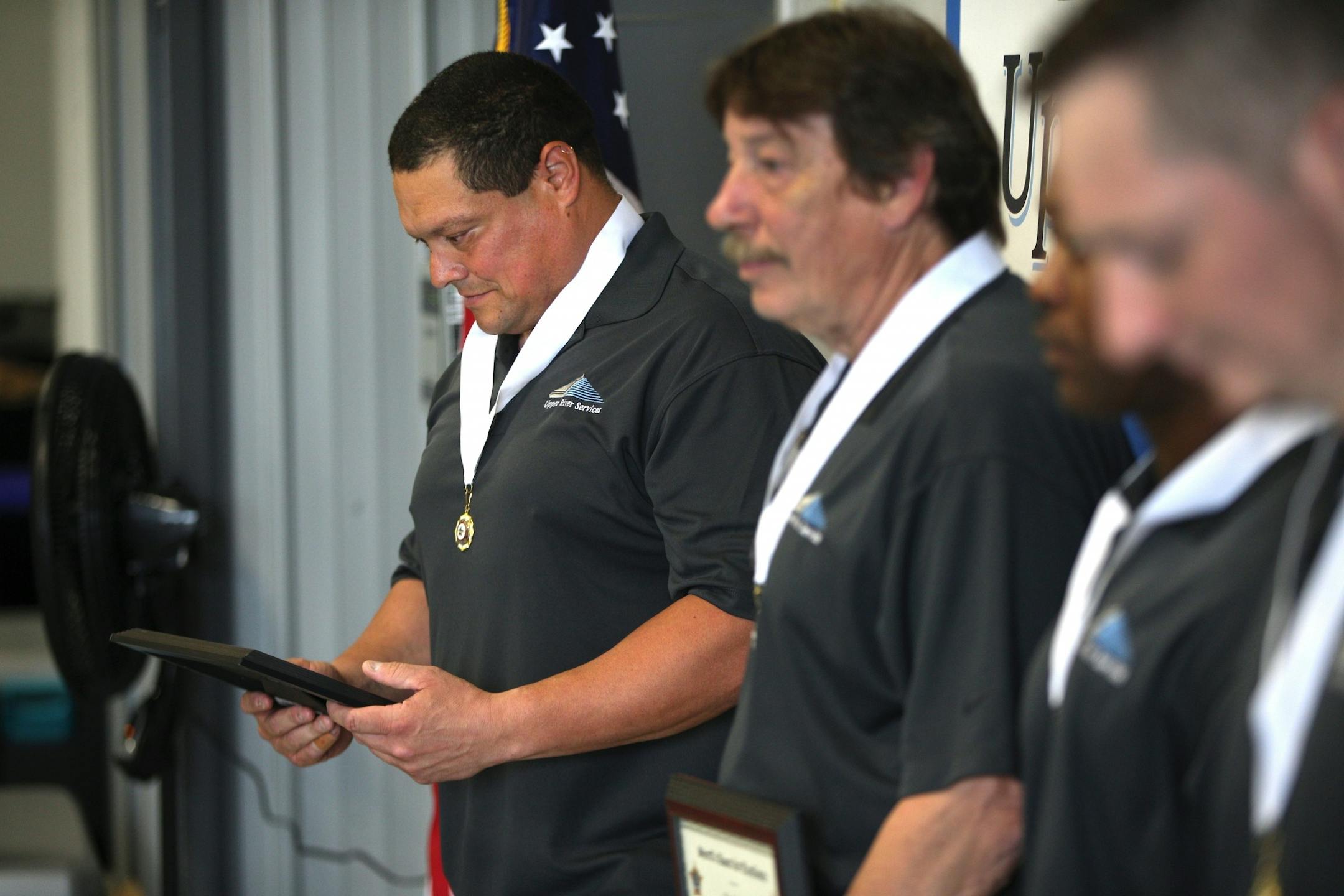 Russ Galvan looked down at his award while being honored on Tuesday.