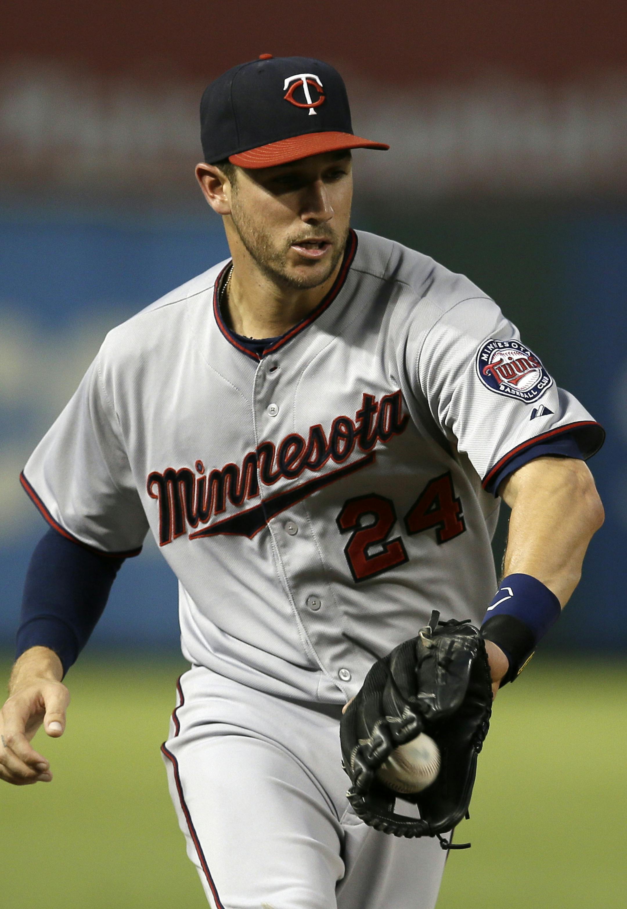 Minnesota Twins third baseman Trevor Plouffe (24) fields a ground out by Texas Rangers' Adam Rosales in the third inning of a baseball game, Saturday, Aug. 31, 2013, in Arlington, Texas. (AP Photo/Tony Gutierrez)
