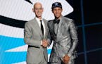 Jalen Suggs, right, posed with NBA Commissioner Adam Silver after being selected fifth overall by the Magic in Thursday’s draft.