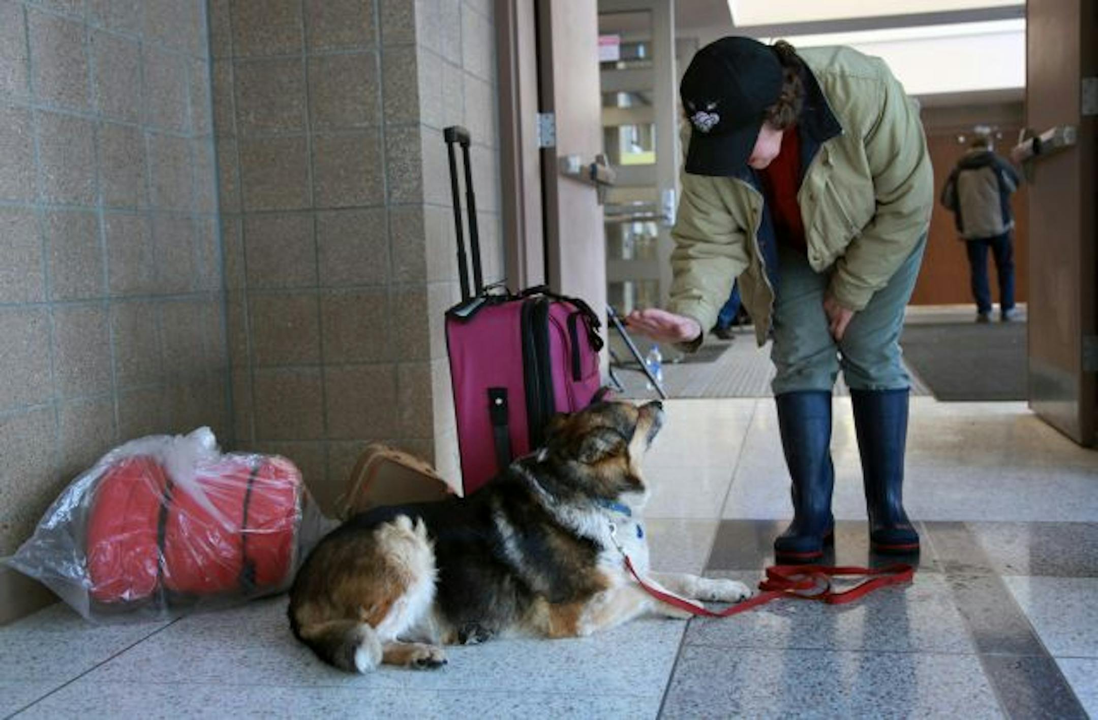 Jessie Swanson went to a Red Cross shelter in Moorhead, Minn., on Friday, only to find out that she couldn't keep her dog, Penny, there. Swanson had been forced to leave her home north of Moorhead and was reluctant to leave her dog at a pet shelter. She decided to go to a motel, for now.