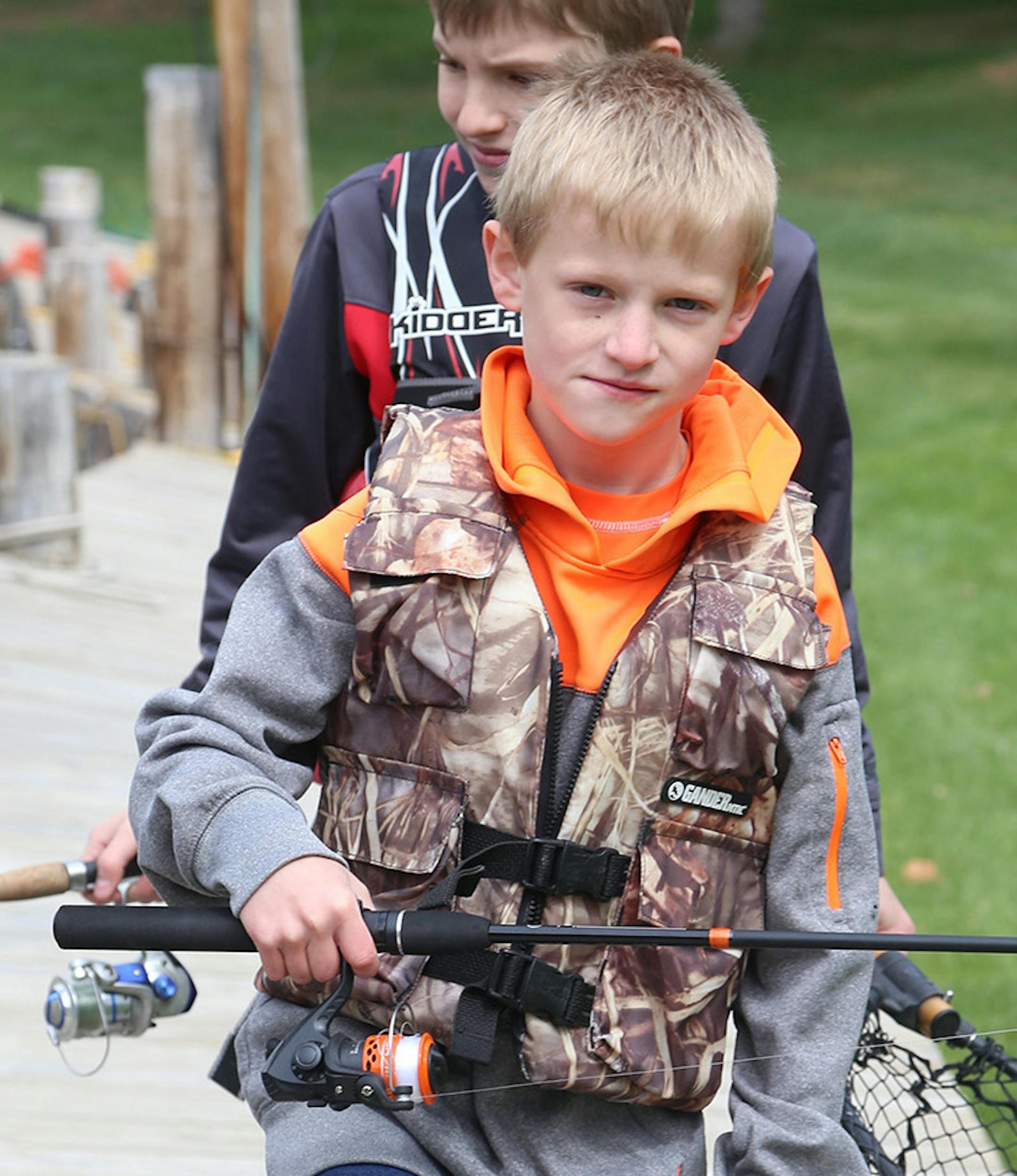 Jacob Pesta, foreground, and his cousin, Bradley Joe Groestch, made life tough for fish on Saturday in the harbor of Big Rock Resort on Leech Lake.