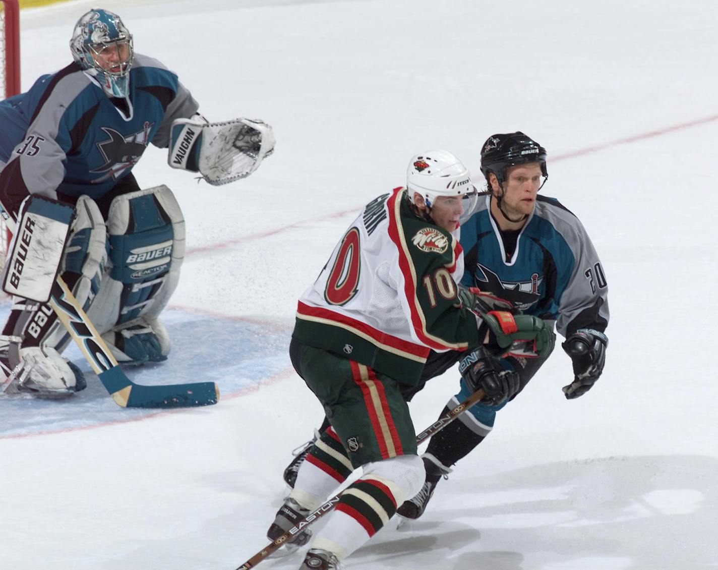 Marian Gaborik of the Wild waits for a pass in front of San Jose goalie Evgeni Nabokov (35) while tussling with defenseman Gary Suter (20) during a game in 2001. Suter was honored for his 18-year career Saturday in San Jose, against the Wild.