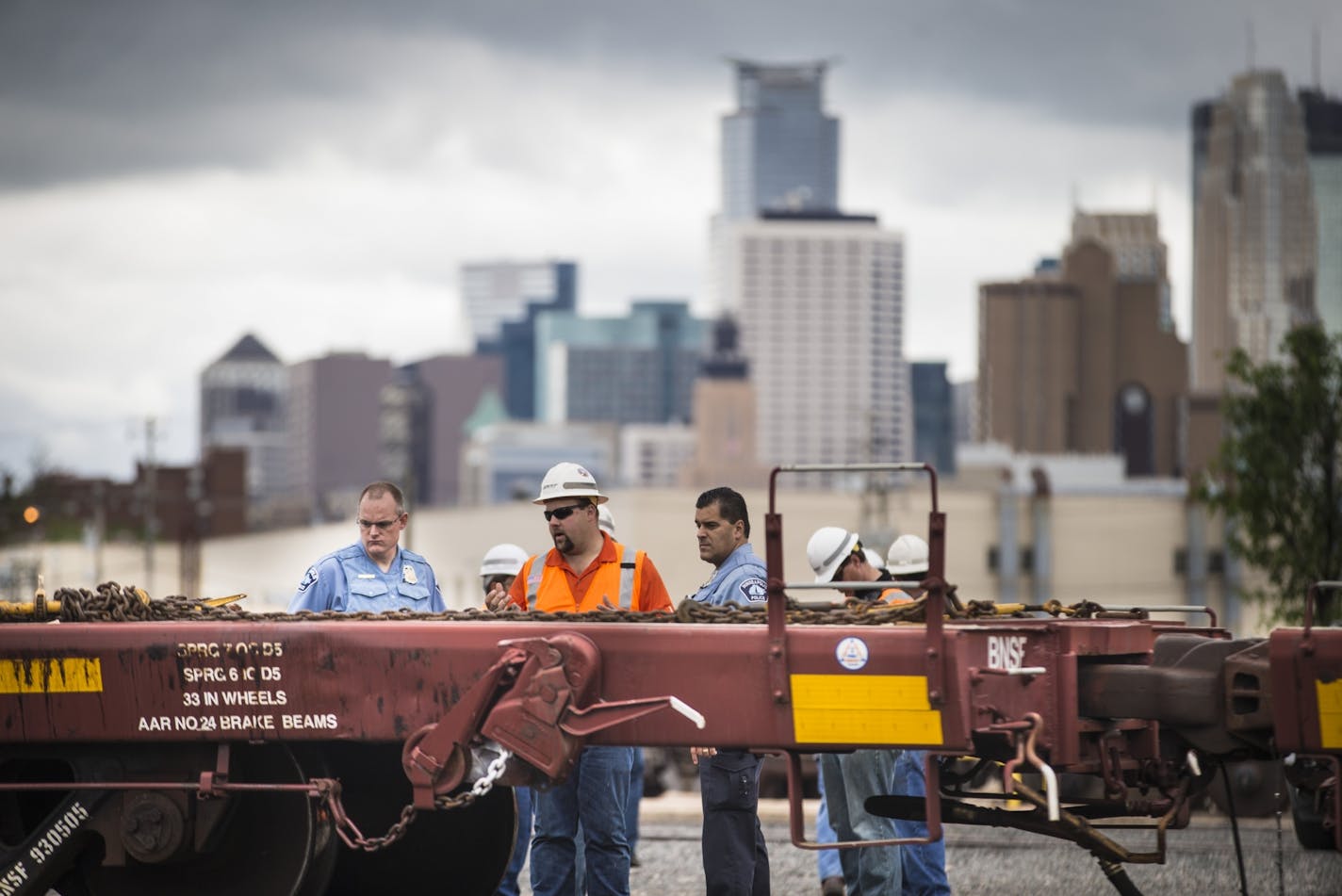 A rail worker spoke to officers at the scene of a fatal incident involving a train at BNSF Railway on Harrison St. in Minneapolis, Minn. on Monday, May 25, 2015.