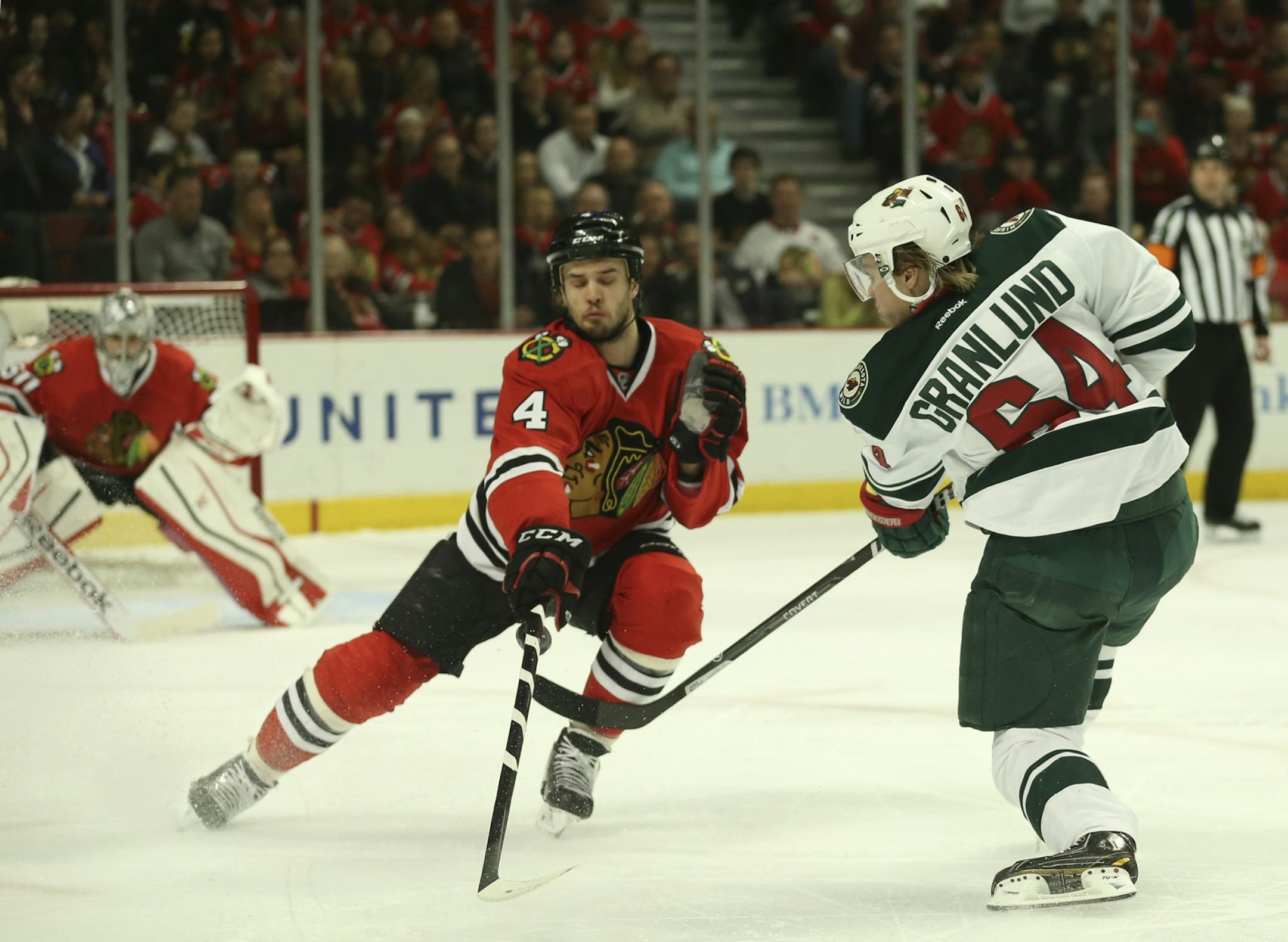 Chicago Blackhawks defenseman Niklas Hjalmarsson (4) blocked a first period shot by Minnesota Wild center Mikael Granlund (64) Sunday afternoon at United Center in Chicago.