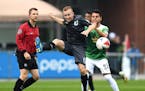 Minnesota United FC midfielder Jamie Watson (13) kicked away the ball while being defended behind by Tampa Bay Rowdies midfielder Michael Nanchoff (23