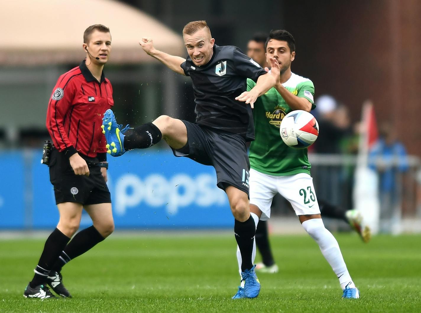 Minnesota United FC midfielder Jamie Watson (13) kicked away the ball while being defended behind by Tampa Bay Rowdies midfielder Michael Nanchoff (23) in the first half Saturday.