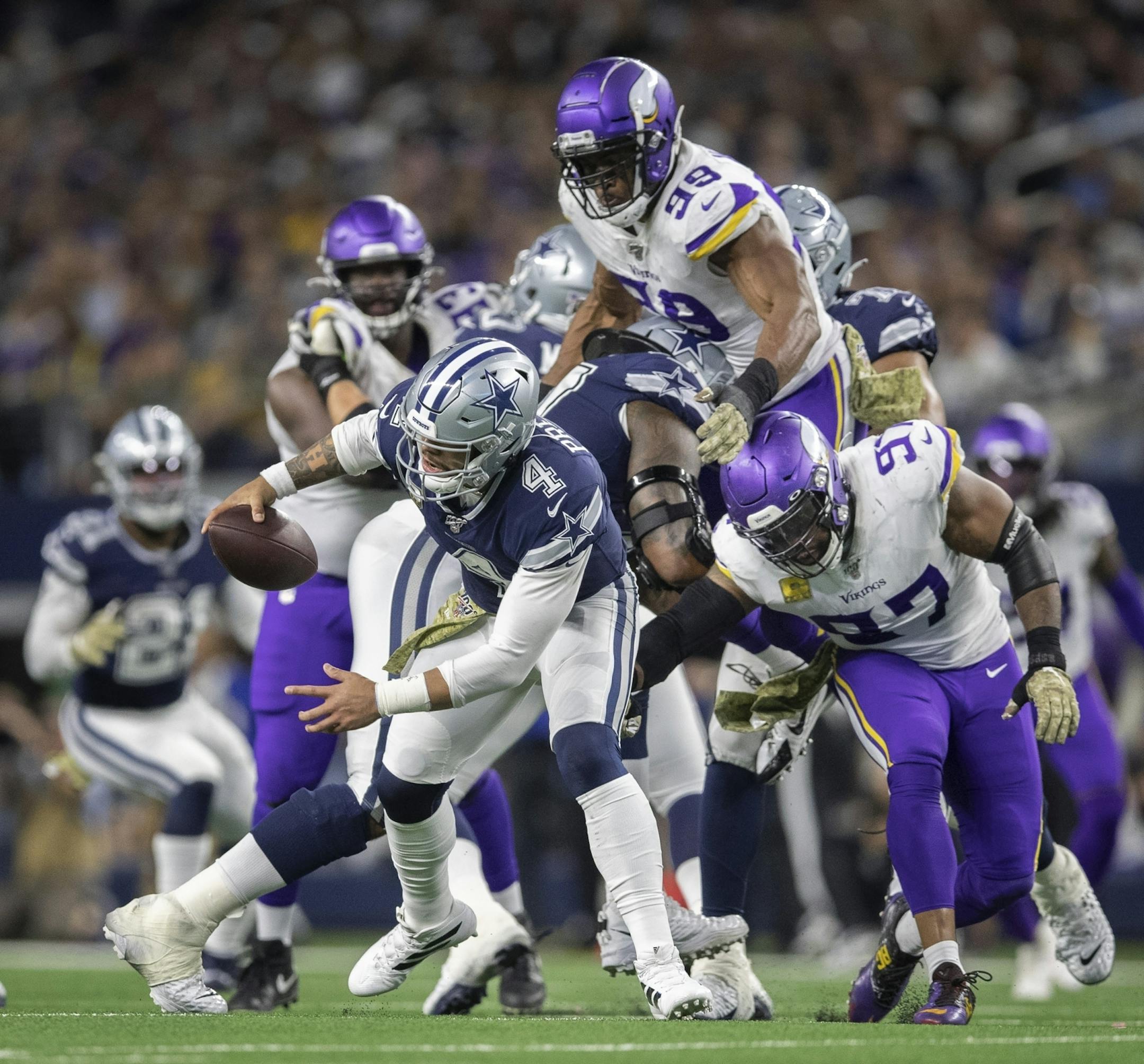 Minnesota Vikings defensive end Danielle Hunter (99) Everson Griffen (97) forced Dallas Cowboys quarterback Dak Prescott (4) out of the pocket in the third quarter at AT&T Stadium.