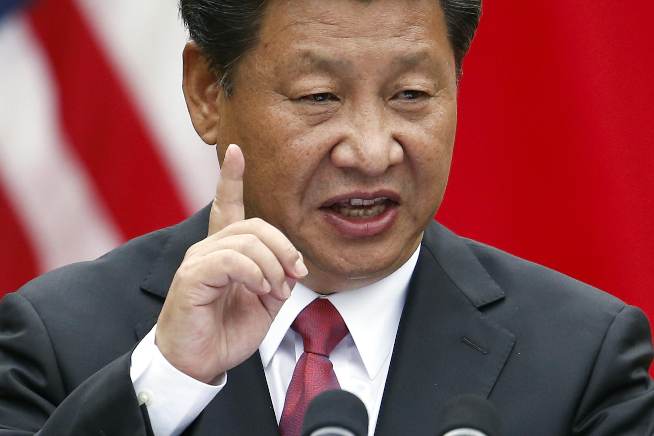 Chinese President Xi Jinping gestures during a joint new conference with President Barack Obama, Friday, Sept. 25, 2015, in the Rose Garden of the White House in Washington. (AP Photo/Evan Vucci)