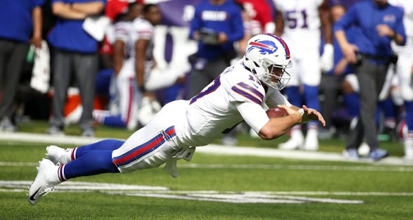 Buffalo Bills quarterback Josh Allen dives for extra yardage during the first half of an NFL football game against the Minnesota Vikings, Sunday, Sept
