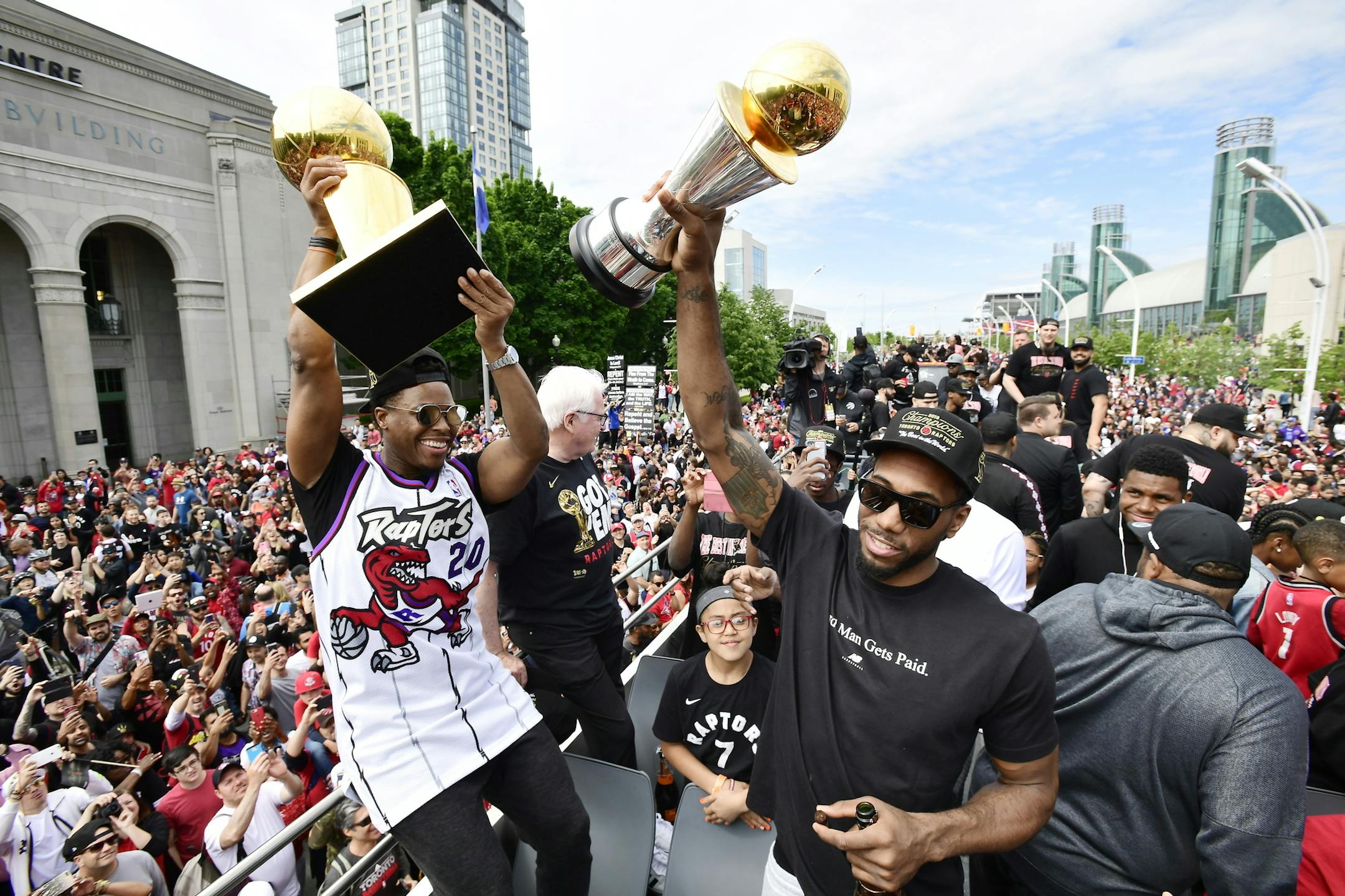 Toronto Raptors guard Kyle Lowry, left, holds the Larry O'Brien Championship Trophy as forward Kawhi Leonard holds his playoffs MVP trophy during the NBA basketball championship team's victory parade in Toronto, Monday, June 17, 2019. (Frank Gunn/The Canadian Press via AP)