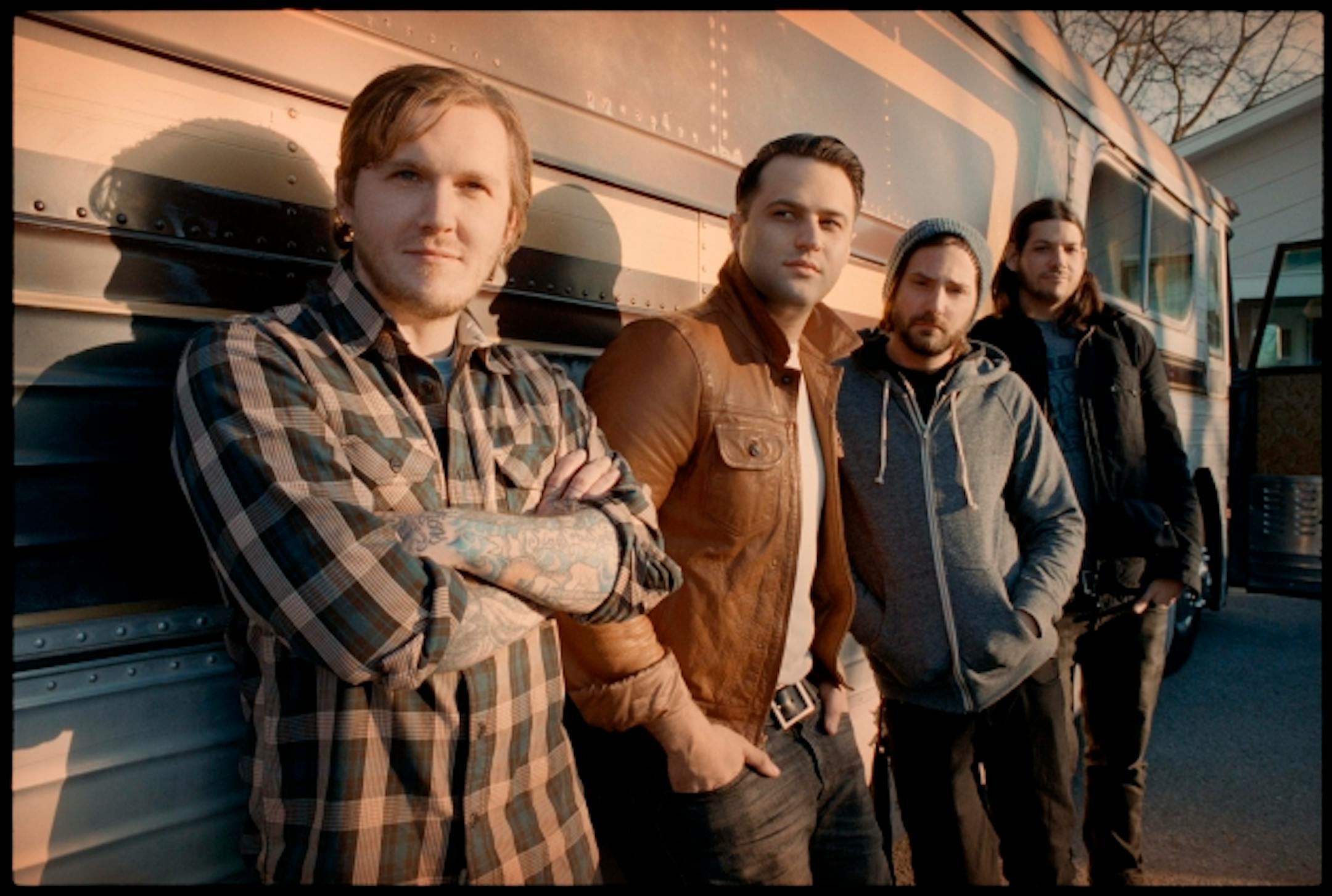 The Gaslight Anthem's members in happier days with their bus, which broke down on the way to Wednesday's sold-out Fine Line gig. / Danny Clinch photo