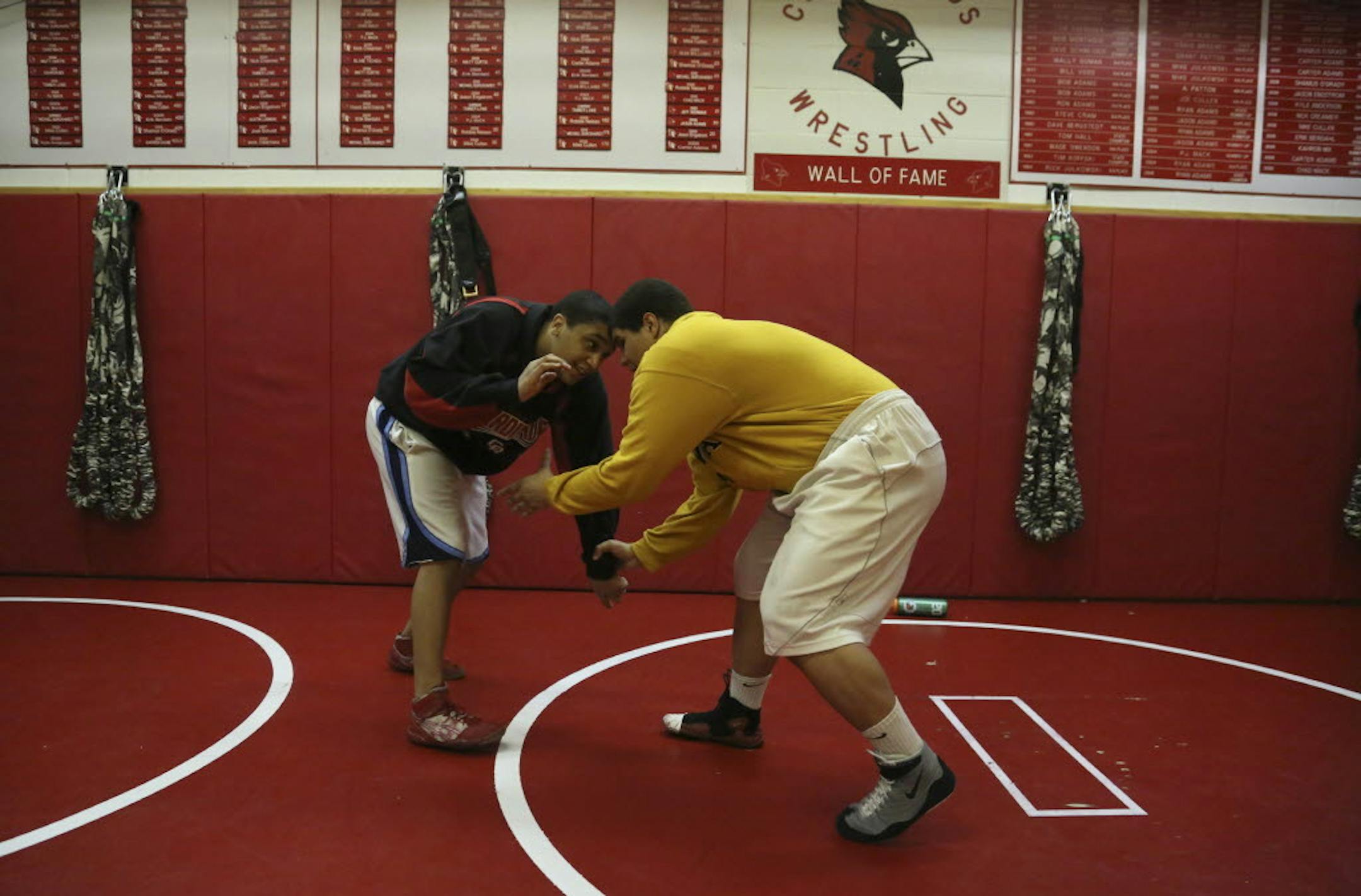 Michael Burckhardt, right, worked out with teammate Jonathan Chmilowsky at Coon Rapids High School, where they are celebrating five decades of wrestling. Photo by KYNDELL HARKNESS • kharkness@startribune.com