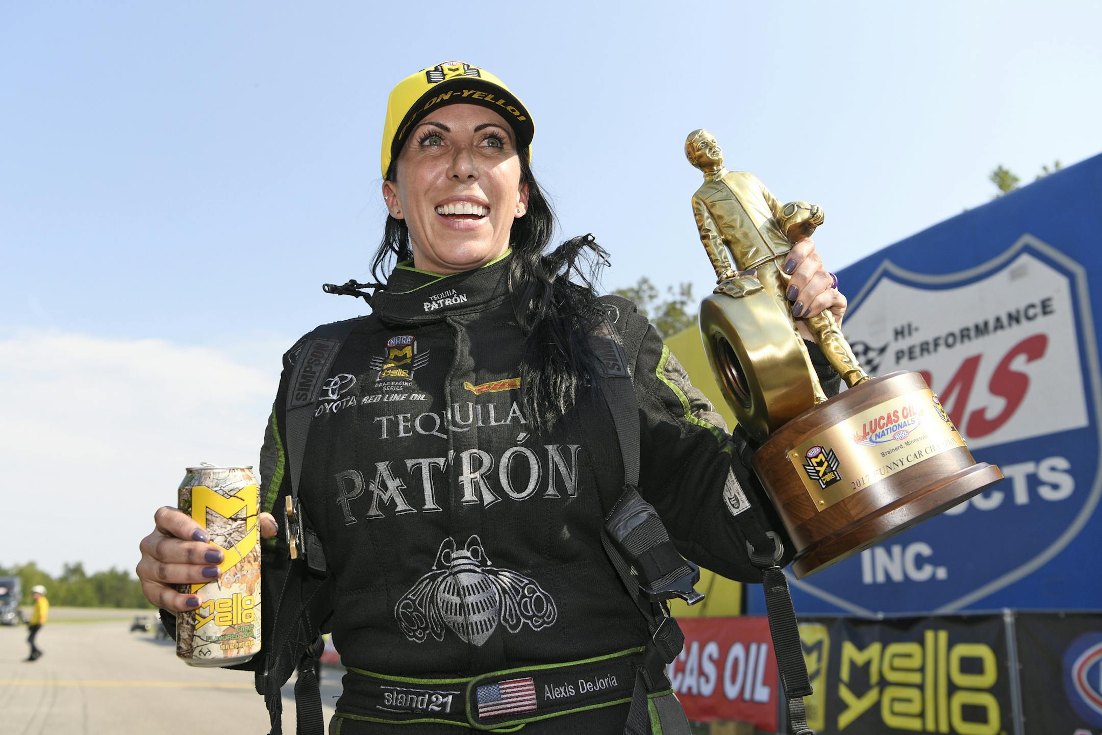 In this photo provided by NHRA, Alexis DeJoria holds the trophy after her first Funny Car win of the season, at the Lucas Oil NHRA Nationals drag races at Brainerd International Raceway on Sunday, Aug. 20, 2017, in Brainerd, Minn. (Jerry Foss/NHRA via AP)