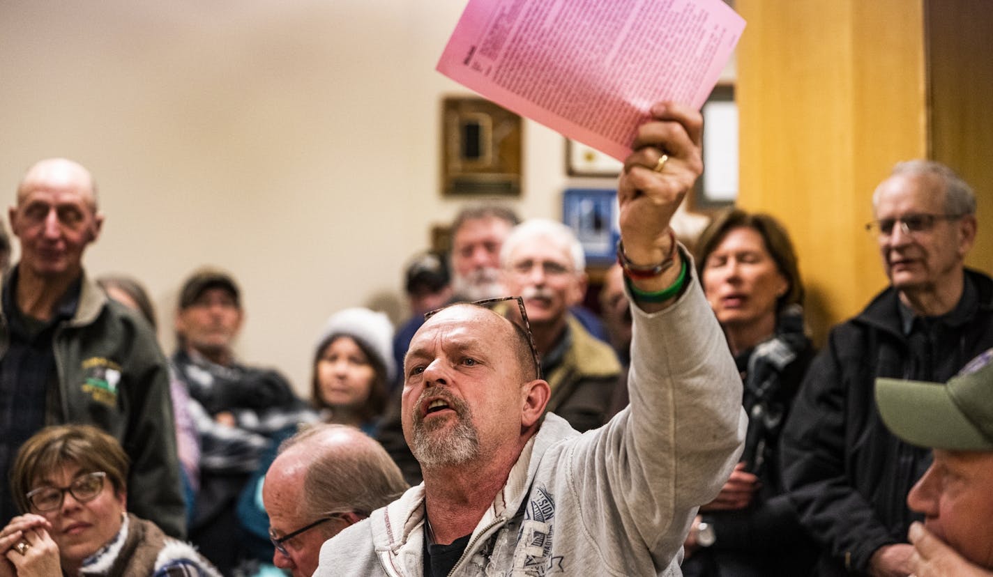 "For me it was always about financial stability," says Mike Rasch, who says the county cannot afford to welcome refugees. He held up copies of his communications with commissioners.