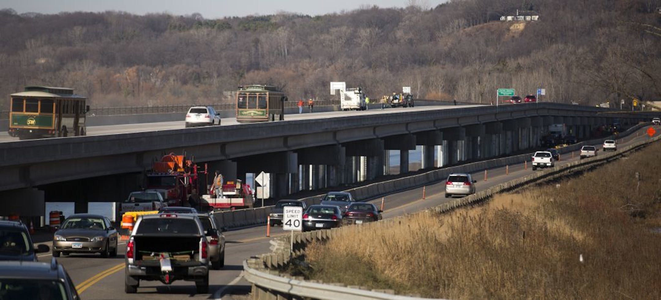 Dozens of residents and leaders from Scott and Carver counties celebrated the opening of the new County Road 101 bridge ( Top) Tuesday morning, walking from opposite ends of the 4,100-foot river crossing for a ceremonial ribbon cutting in the middle. The old 101 crossing, still in use Tuesday morning, is to the right of the new span.