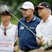 CORRECTS TO FOURTH HOLE, NOT SECOND HOLE - Blaine McCallister, right, tees off on the fourth hole, as Nick Price, center, looks on during the first ro