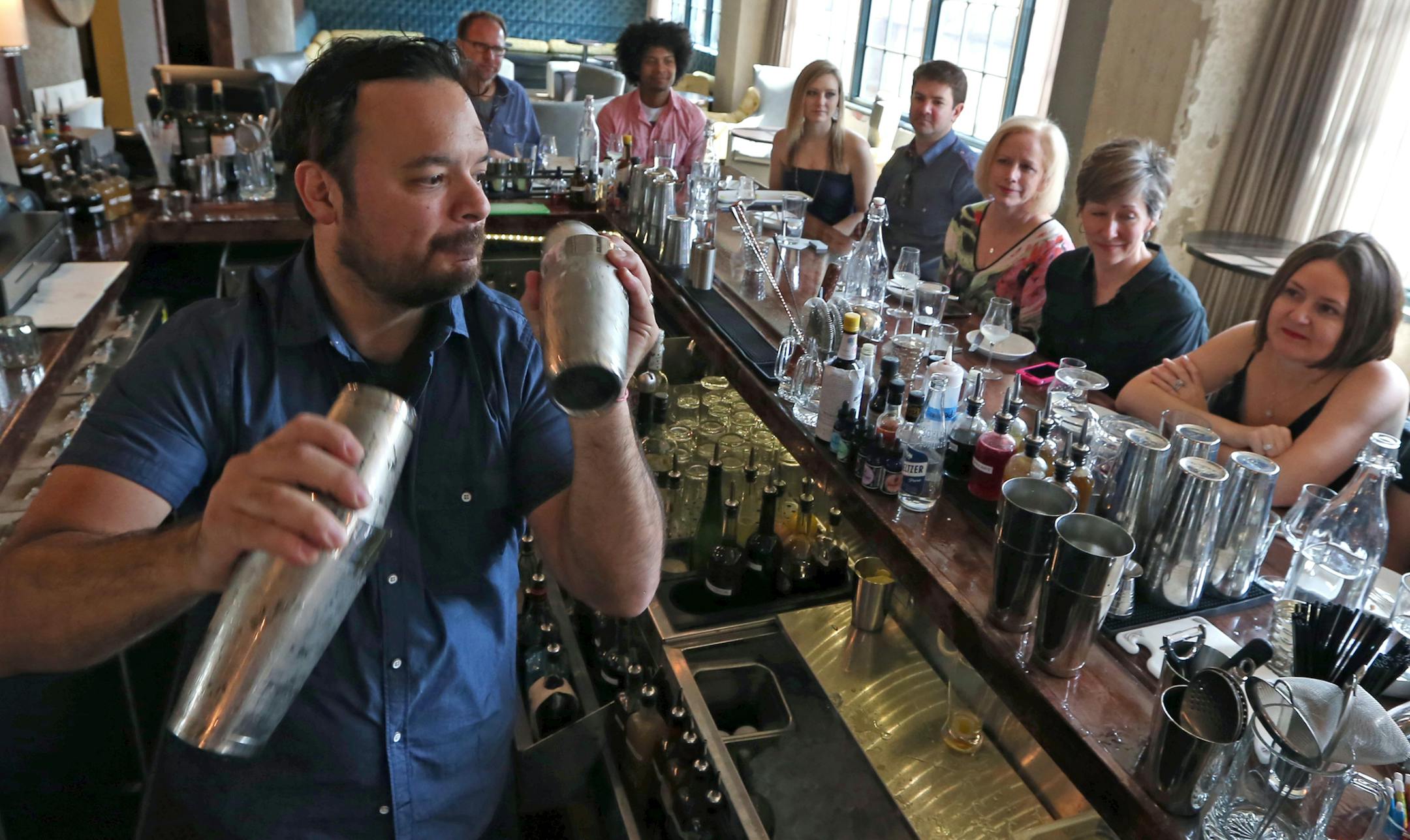(left to right) Jesse Held instructed students Chris Cox, Brent Webb, Melissa Kuchar, Trey Kuchar, Patty McMonigal, Kris Lang and Cherrie Heinrich, as he made drinks at Parlour's cocktail class, with a small group of students learning from the cocktail guru/professor on 5/17/14. Nightlife feature on cocktail classes, where people sign up to learn tricks of the trade from notable local bartenders at places like Parlour and Bachelor Farmer.] Bruce Bisping/Star Tribune bbisping@startribune.com Jess