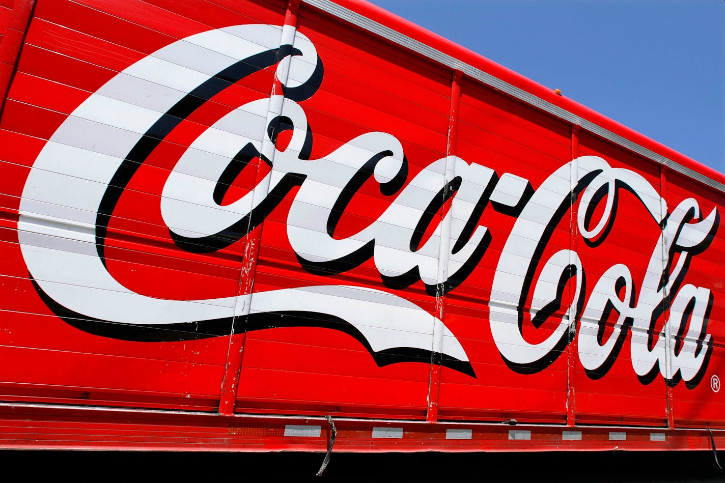 This Monday, June 25, 2012 photo shows the Coca-Cola logo on the side of a delivery truck in Springfield, Ill. Coca-Cola, the world's biggest beverage maker, is working with fitness and nutrition experts who suggest its cola as a healthy treat. (AP Photo/Seth Perlman)