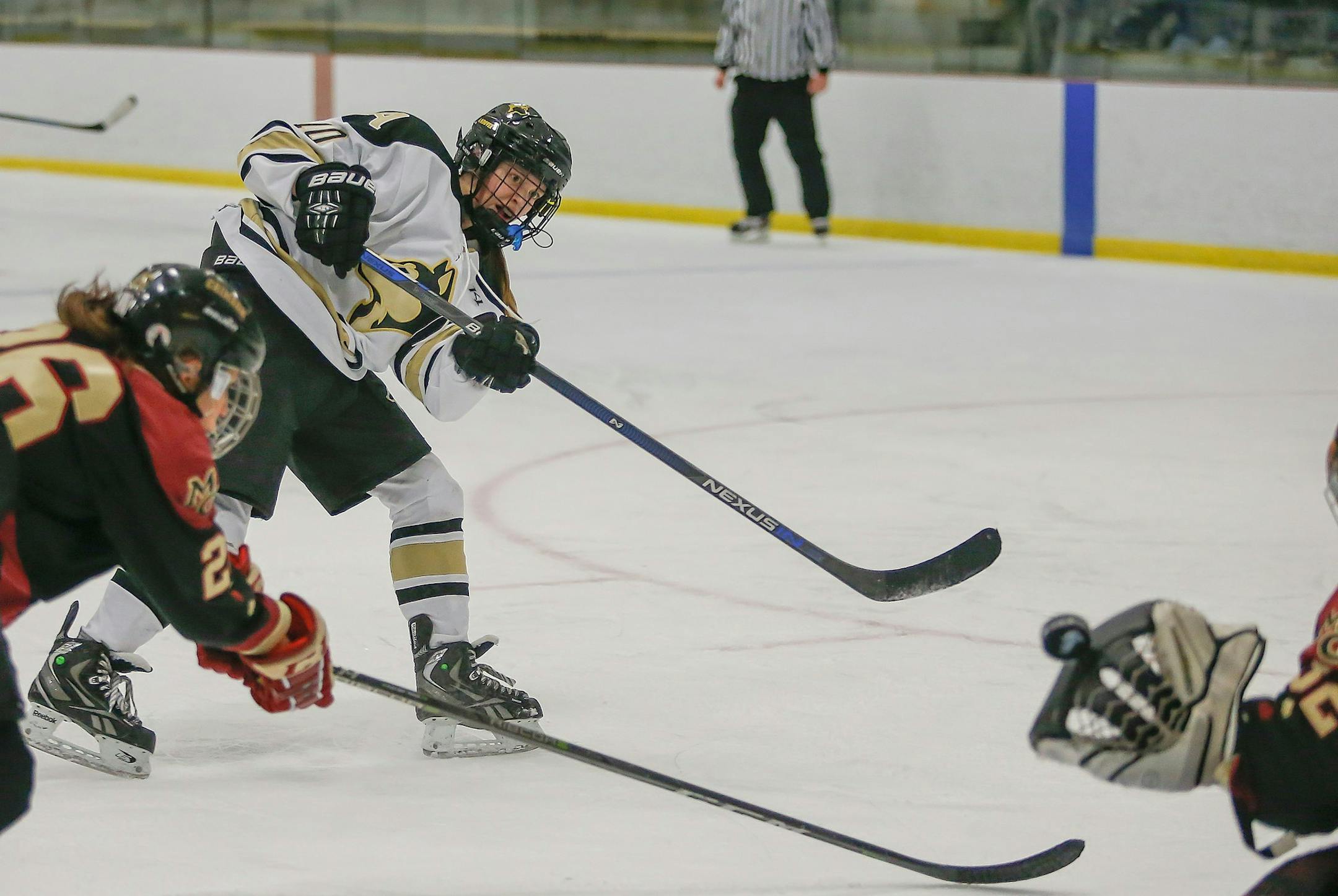 Andover sophomore forward Jamie Nelson shoots the puck in a home game against Maple Grove on Jan. 9. Photo by Mark Hvidsten, SportsEngine
