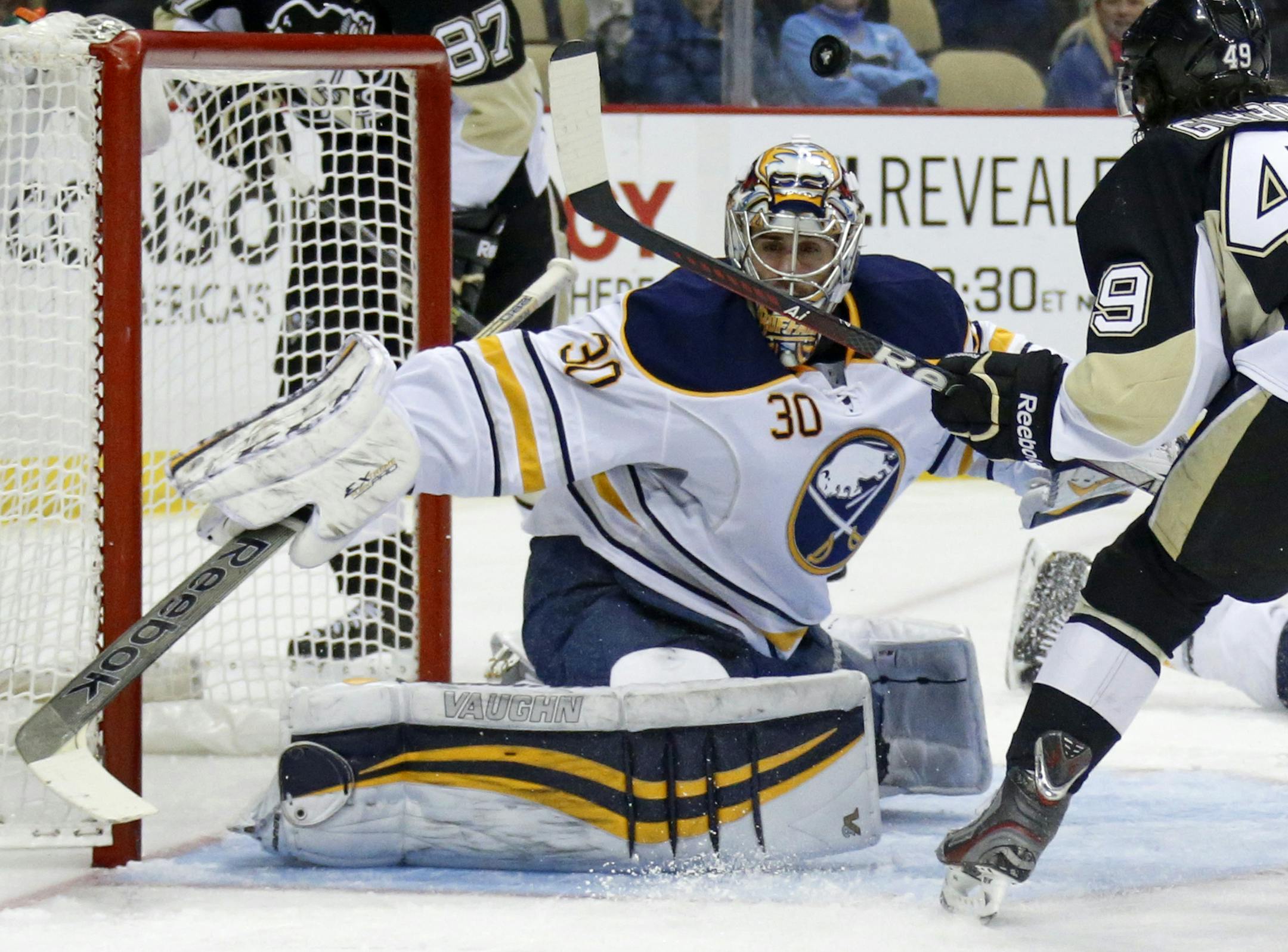 Buffalo Sabres goalie Ryan Miller (30) makes the save on a shot by Pittsburgh Penguins' Brian Gibbons (49) in the second period of an NHL hockey game between the Pittsburgh Penguins and the Buffalo Sabres in Pittsburgh, Monday, Jan. 27, 2014. (AP Photo/Gene J. Puskar)